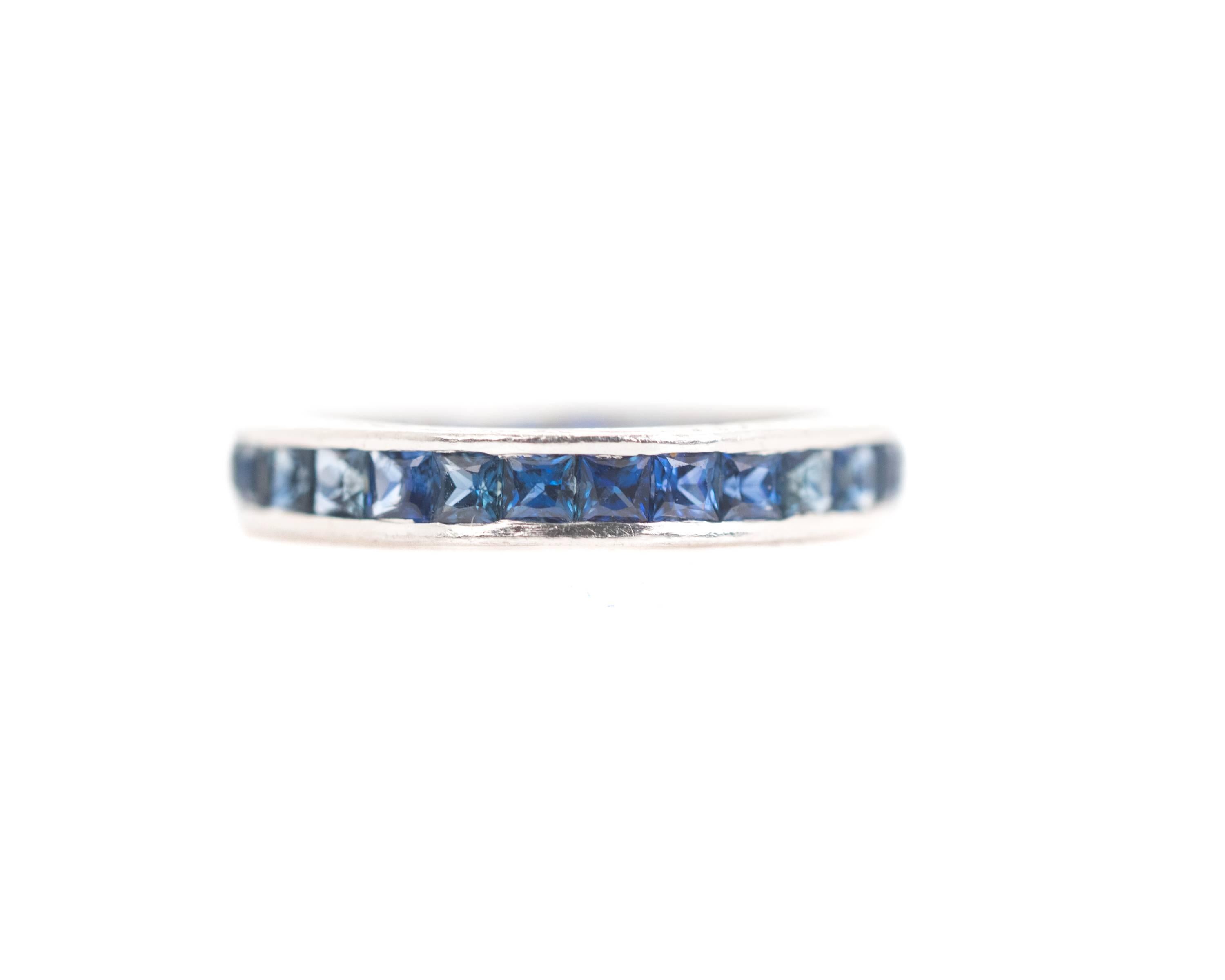 1940s Retro Sapphire & Platinum Eternity Band

Features 2.0 carats of square French cut Sapphires. The upper and lower edges of the ring are hand engraved with a flowing scrollwork design. The face of the ring sparkles with channel set, square