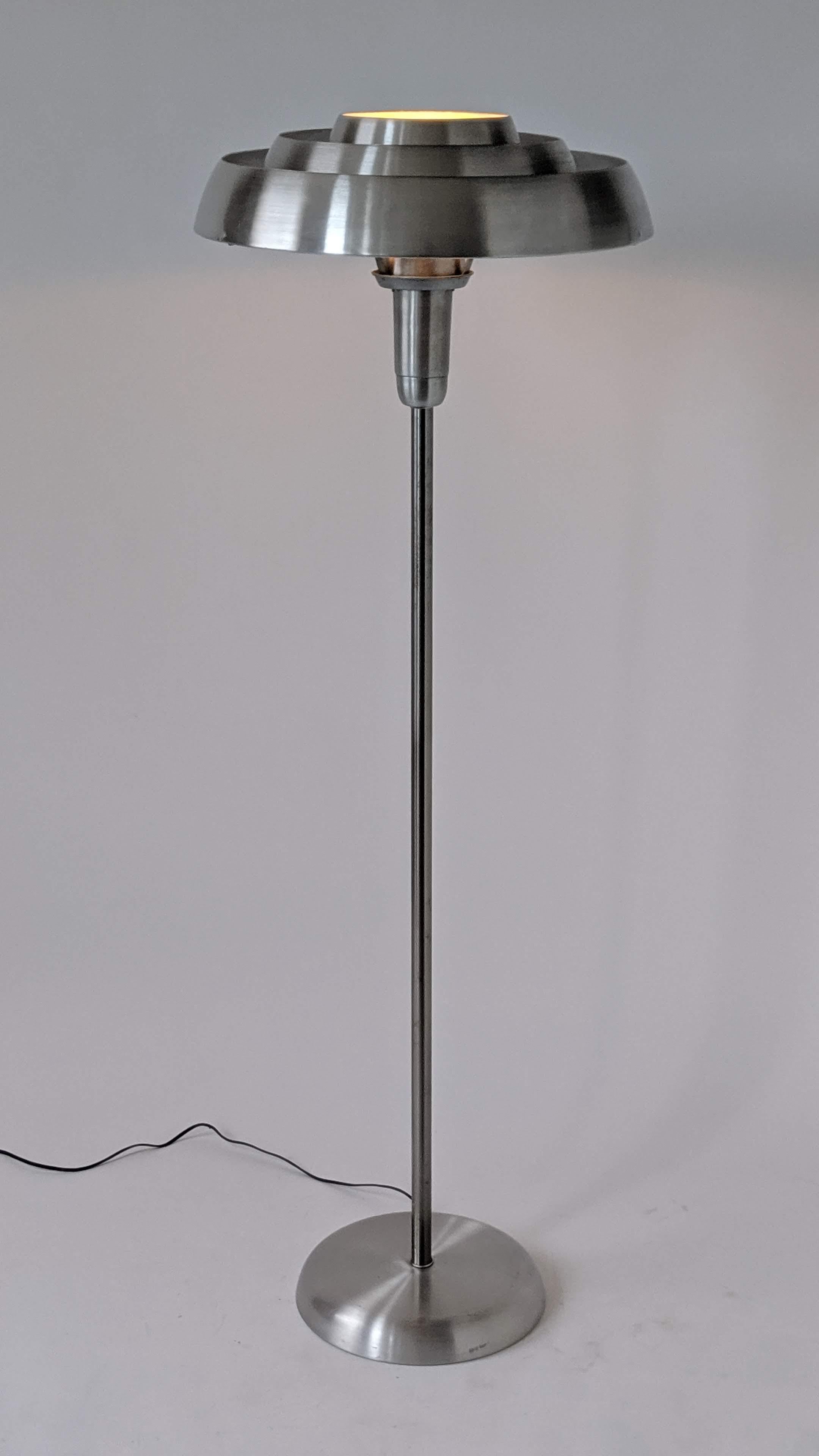 Bold futuristic Art Deco, machine age, streamline floor lamp.

The stacked ring provide an indirect lighting.

Well designed solid construction made of brushed spun aluminium.

Contain one E26 size socket rated at 300 watt.

Second floor