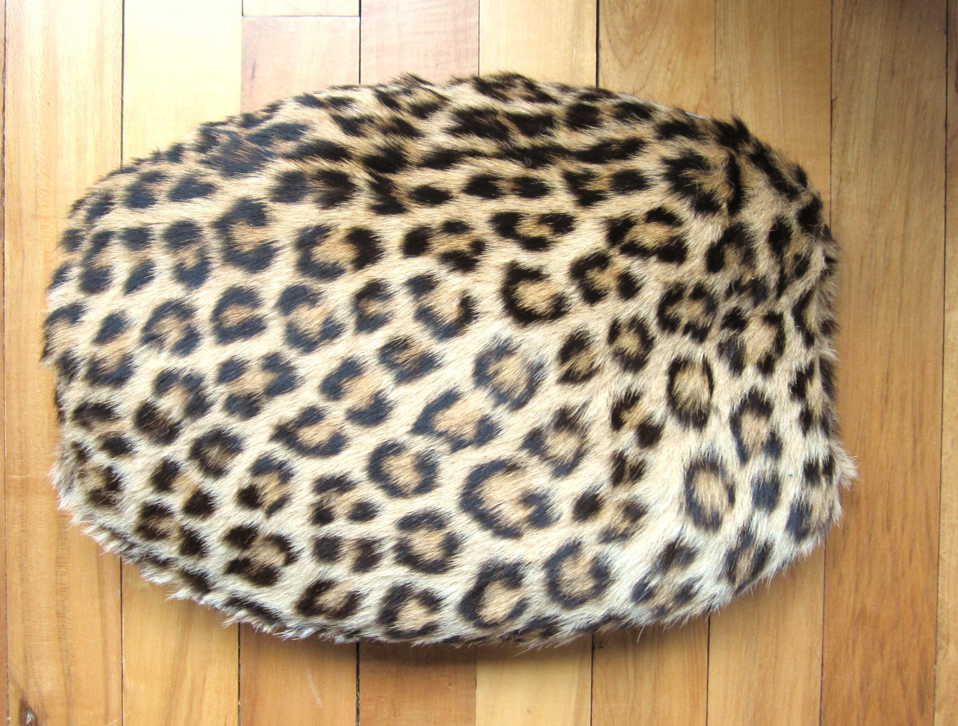 Stunning Leopard print vintage muff. Soft & Supple, no rips or smells. Zippers open on the top with opening to keep your hands toasty warm. Measures 14in. wide x 11in. high. Zipper does not close (about an 1