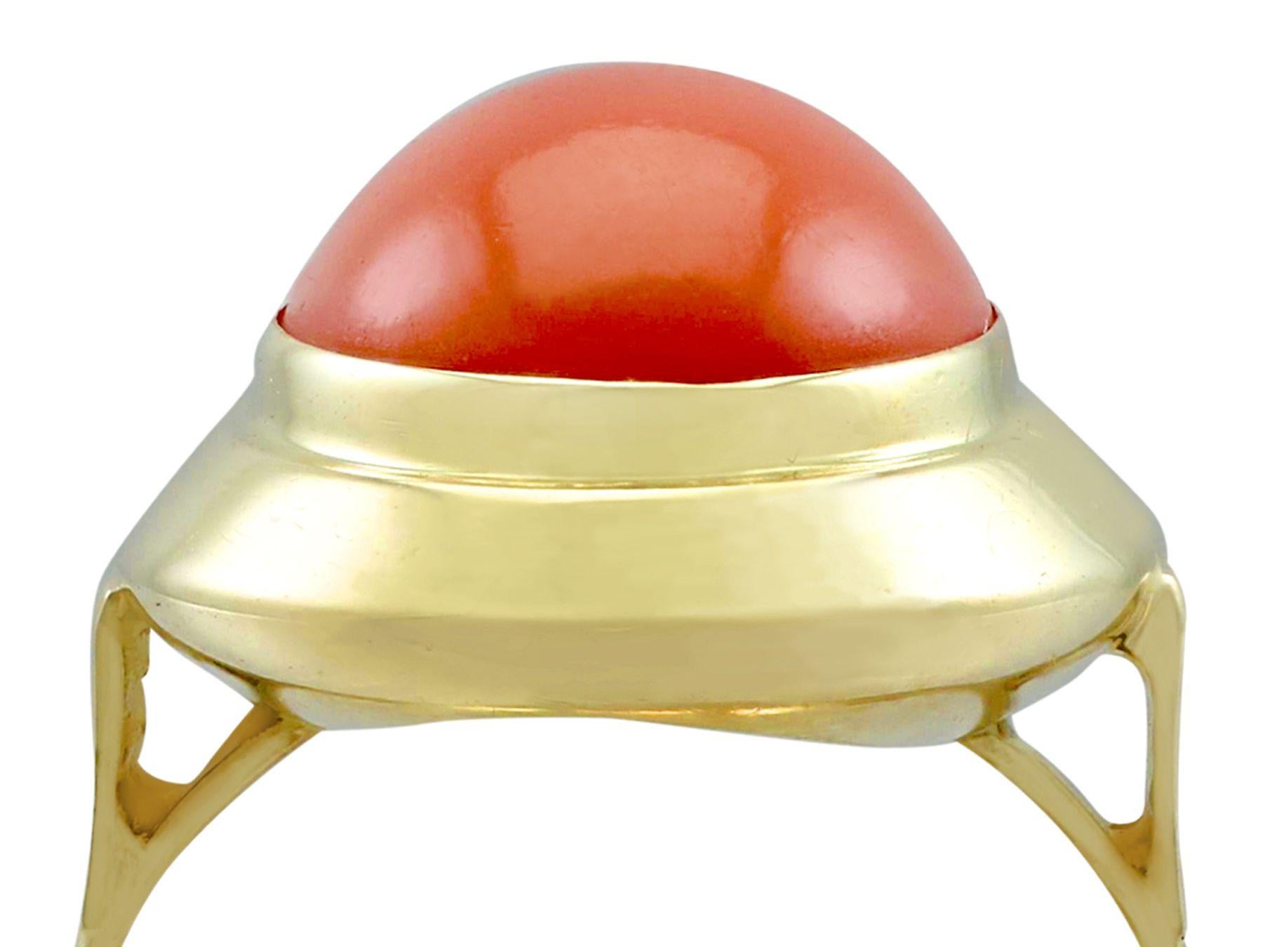 An impressive vintage 5.75 carat red coral and 14 karat yellow gold cocktail ring ring; part of our diverse gemstone jewelry and estate jewelry collections.

This impressive red cabochon cut coral ring has been crafted in 14k yellow gold.

The