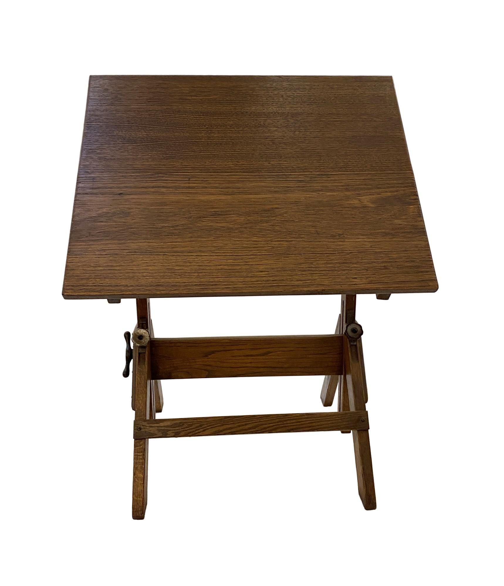 Being offered is a 1940s refinished oak drafting table, that was originally used at a Brooklyn trade college. This is a multi-purpose drafting table/stand-up desk/dining table. Using the original knobs, you can adjust the height and the tilting top.