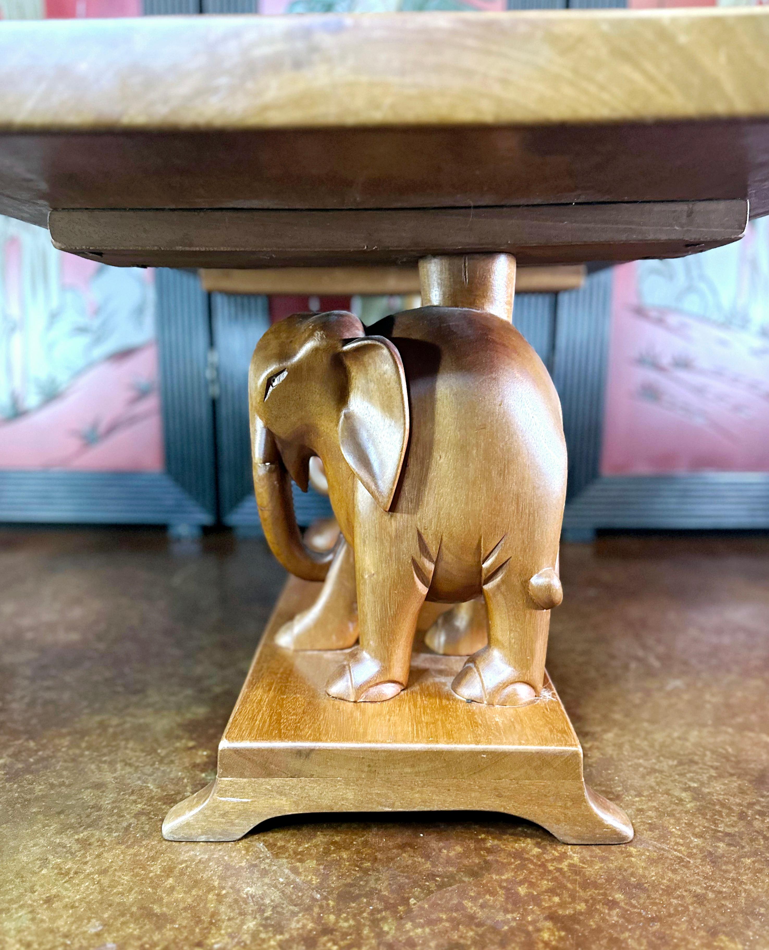 Dies ist ein dekorativer Vintage Couchtisch. Asiatischer Beistelltisch aus Mahagoni mit Elefantenfiguren, aus der späten Art Déco-Periode, um 1940.

Ein charaktervolles und farbenfrohes Produkt für das Wohnzimmer oder jeden anderen Raum. 
Zeigt eine