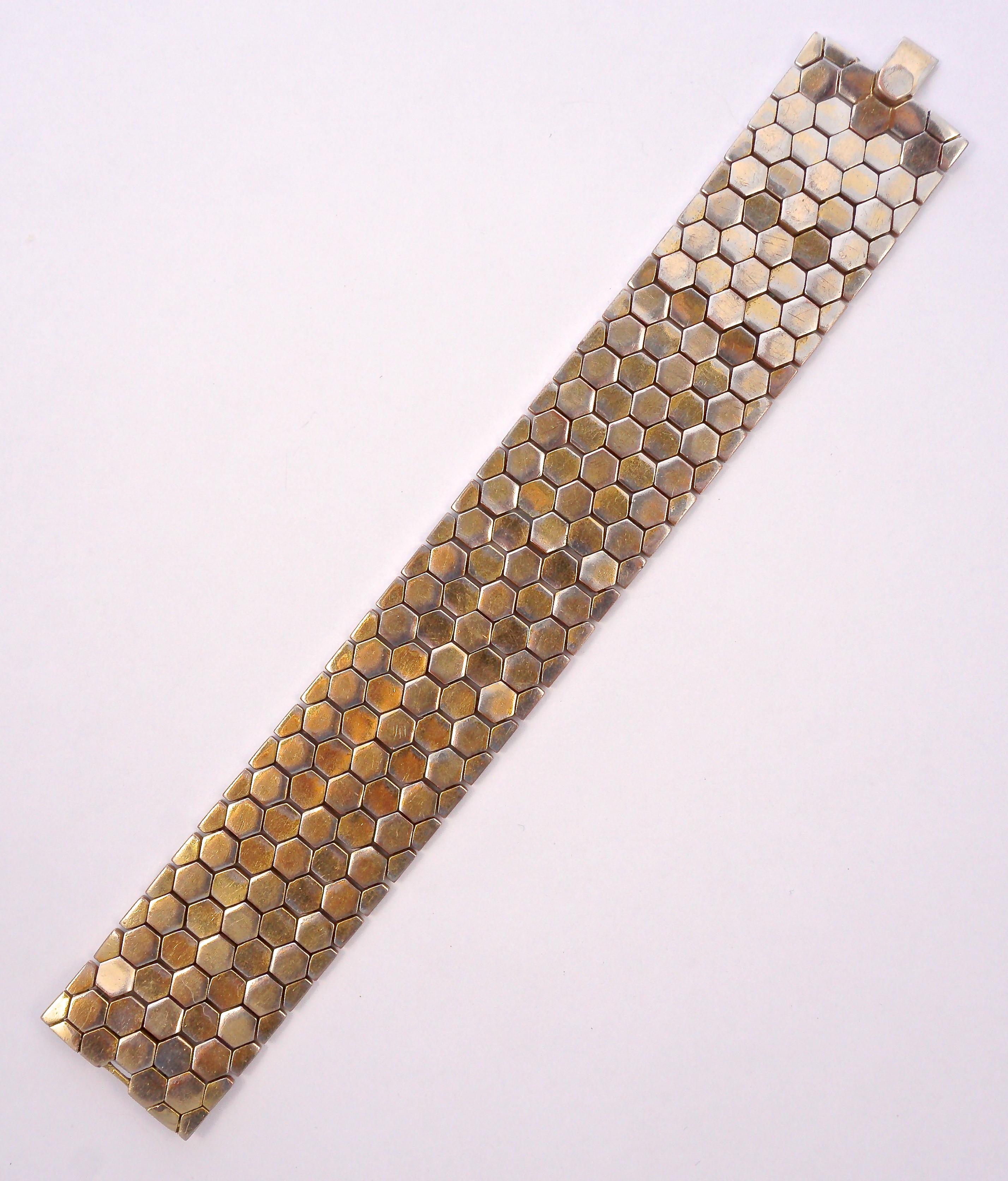 Beautiful Alfred Philippe Trifari gold plated wide bracelet featuring a lovely tessellated honeycomb design. The clasp is stamped Trifari and Design Patent number 143,439, which was filed in 1945. Measuring length 18.7cm / 7.36 inches by width