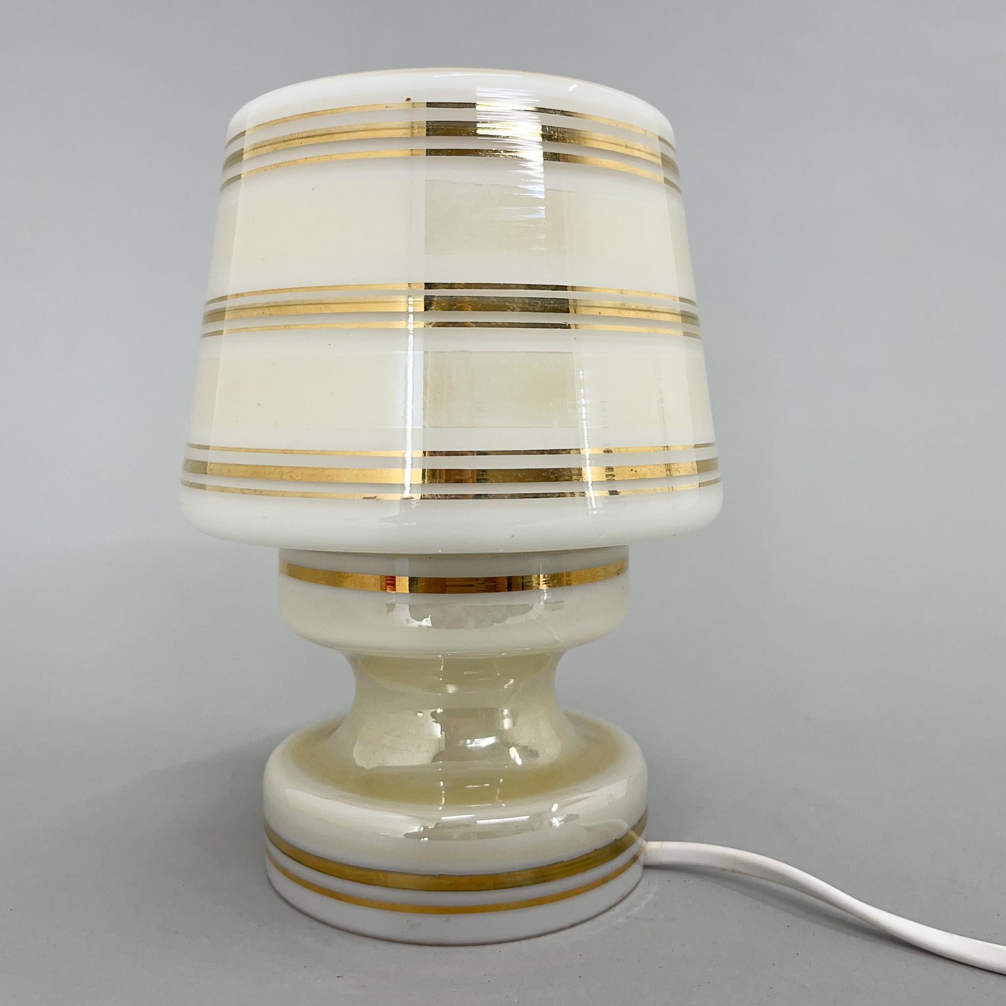 Little bedside lamp from the 1940's. Made of glass with golden decor. 
Bulbs: 1x E25-27.
