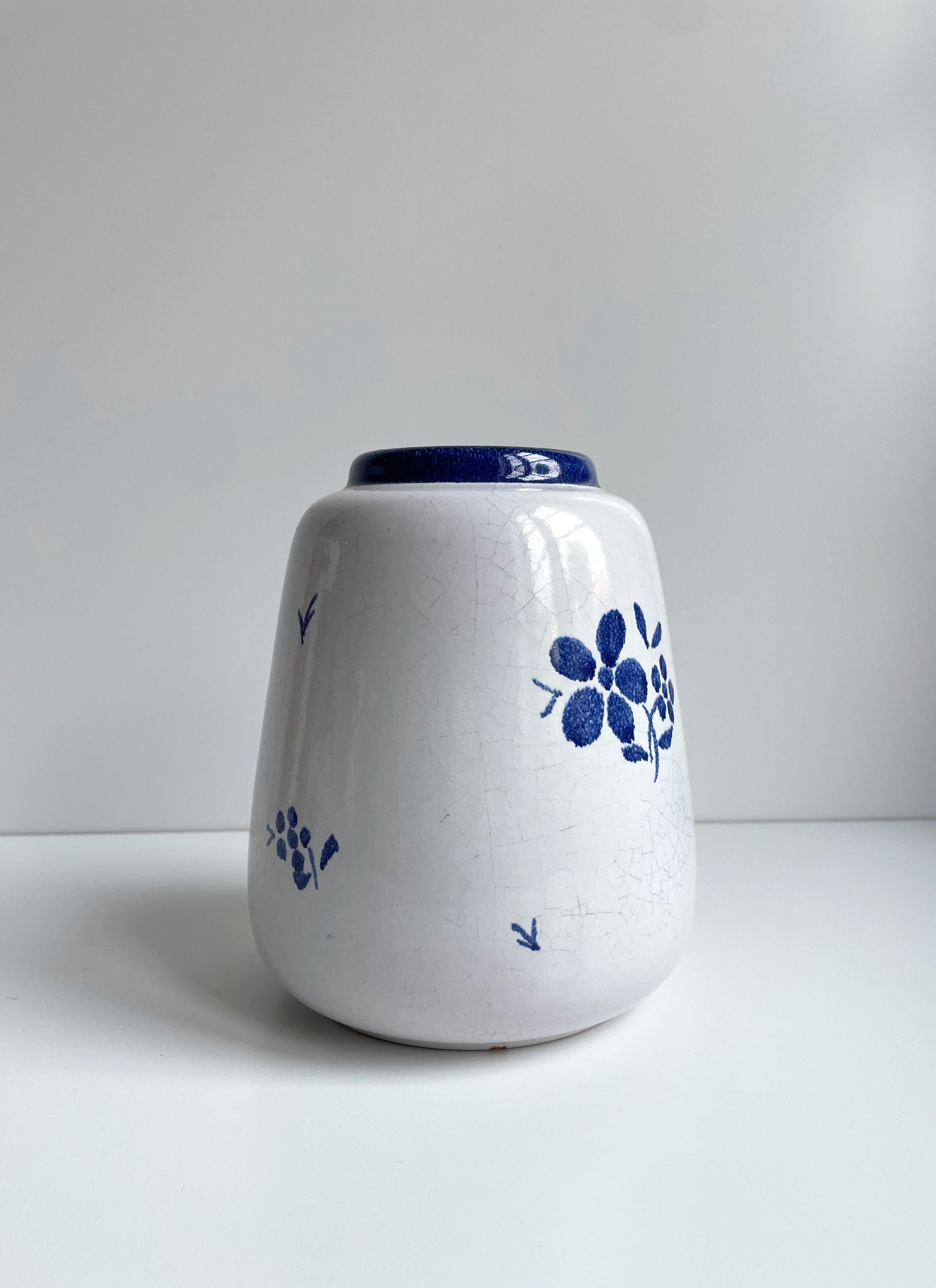 Pretty Nordic almue style ceramic vase with hand-painted admiral blue floral decor on white crackle glaze. Manufactured by Søholm on the Danish island of Bornholm in the early 1940s. Signed under base. Great vintage condition consistent with