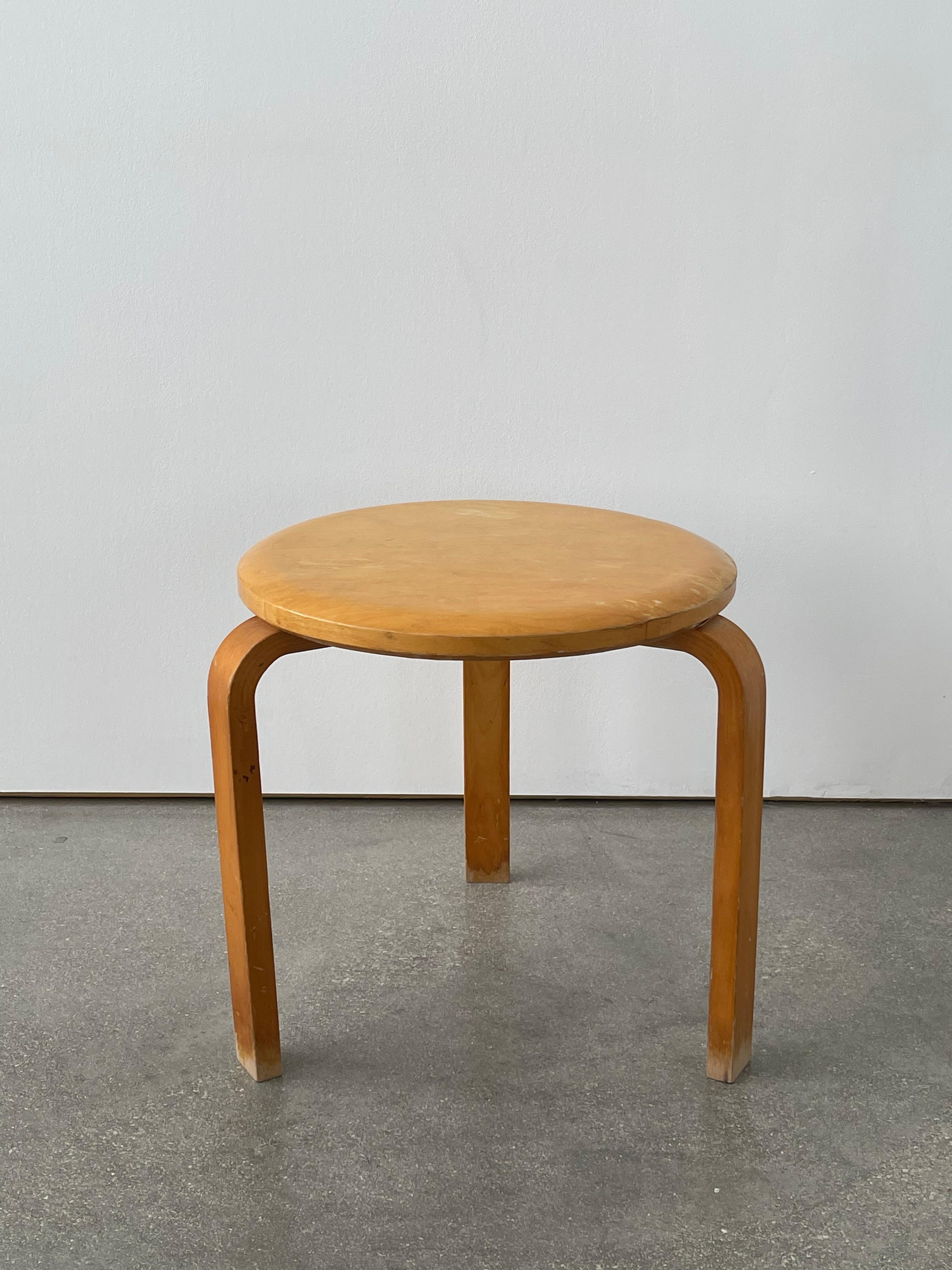 1940's Alvar Aalto Birch stool with a shaped wooden top veneered in birch. 3 Bent wood legs with a four screw attachment. Stamped 