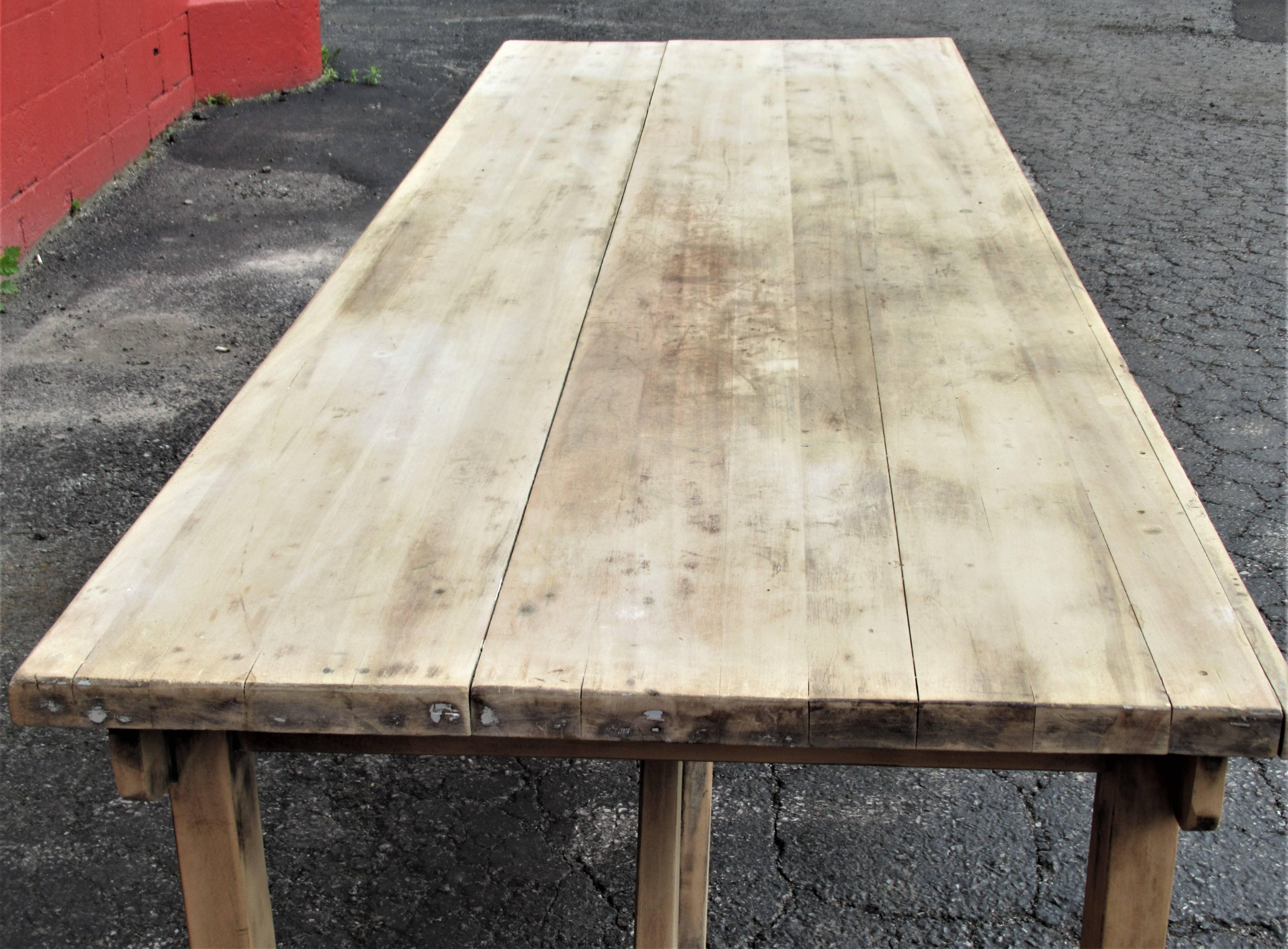 Industrial rustic long rectangular harvest style dining table with an all over bleach washed pale vellum colored surface and a beautifully constructed architectonic form, American, circa 1940s.  
