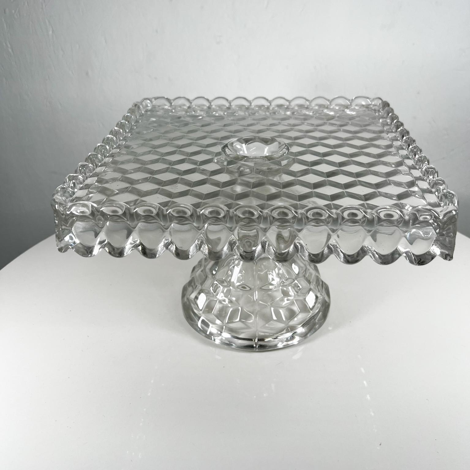 Antique Vintage Fostoria American series clear stem square cake stand 
With Pedestal base rum well and ruffled edge
10.38 x 10.38 x 7 tall
Preowned original vintage condition.
Review images provided.
