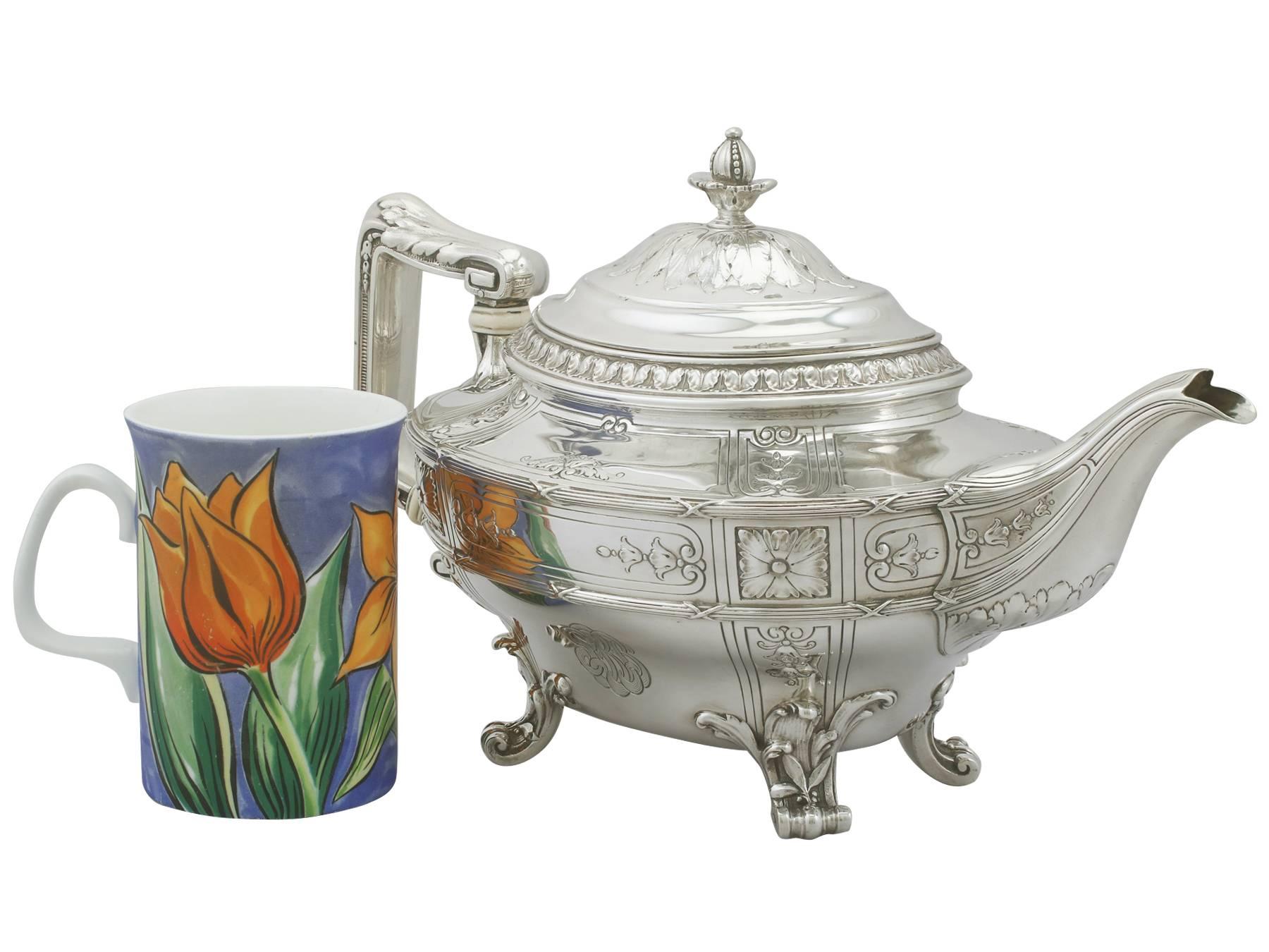 A magnificent, fine and impressive, large vintage American sterling silver teapot by Gorham Manufacturing Company; an addition to our silver teaware collection.

This exceptional antique American sterling silver teapot has an oval shaped