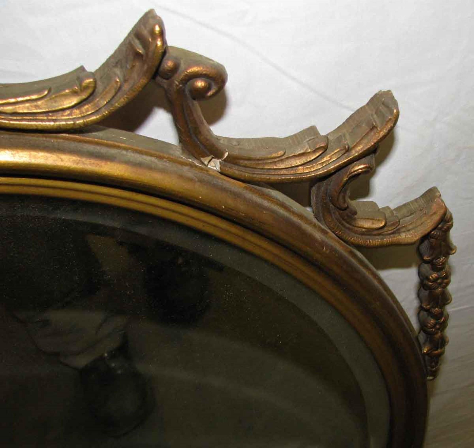 American 1940s Antique Hand Carved Wood Frame with Oval Beveled Mirror Done in Gold Gilt
