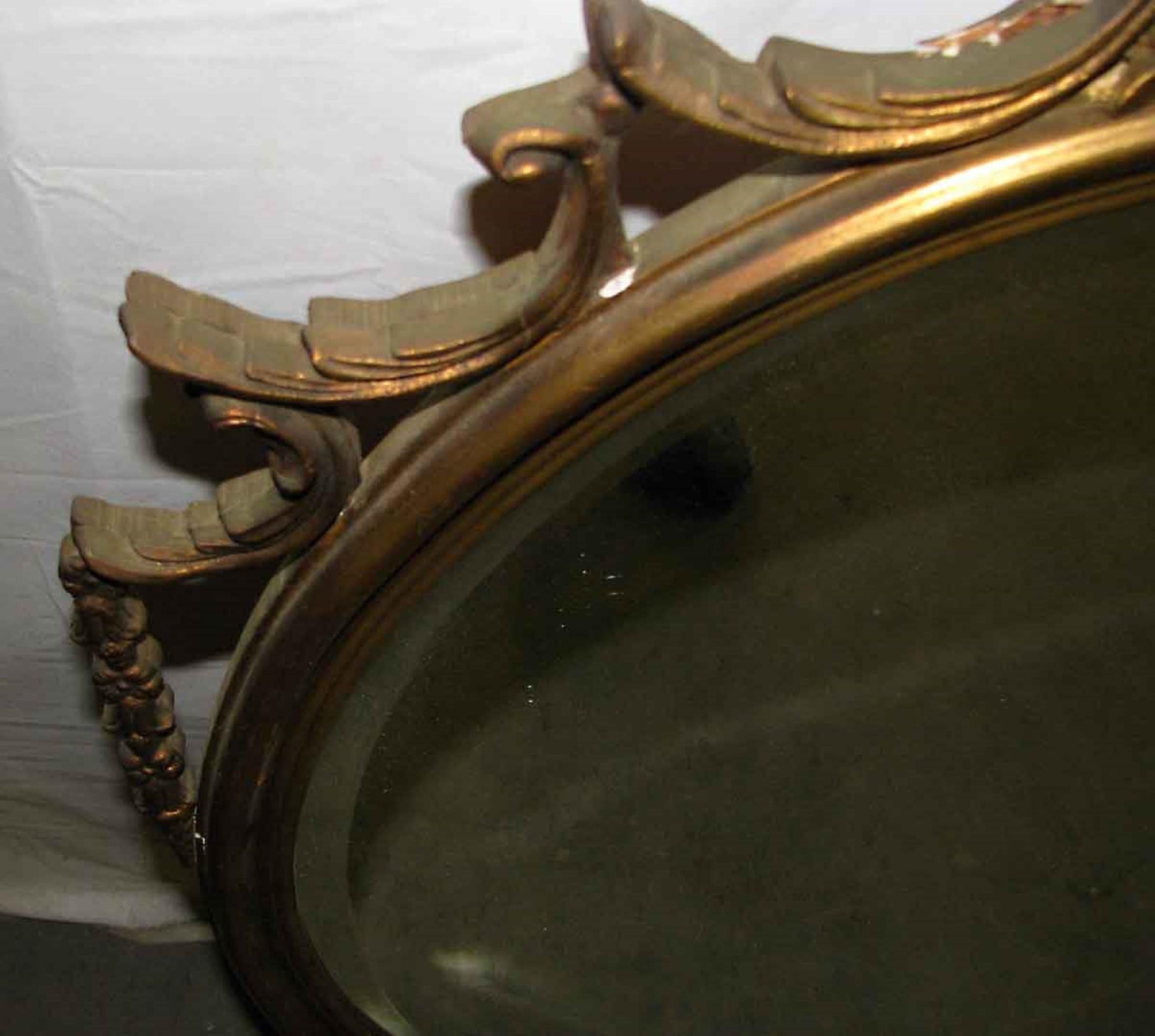 Mid-20th Century 1940s Antique Hand Carved Wood Frame with Oval Beveled Mirror Done in Gold Gilt