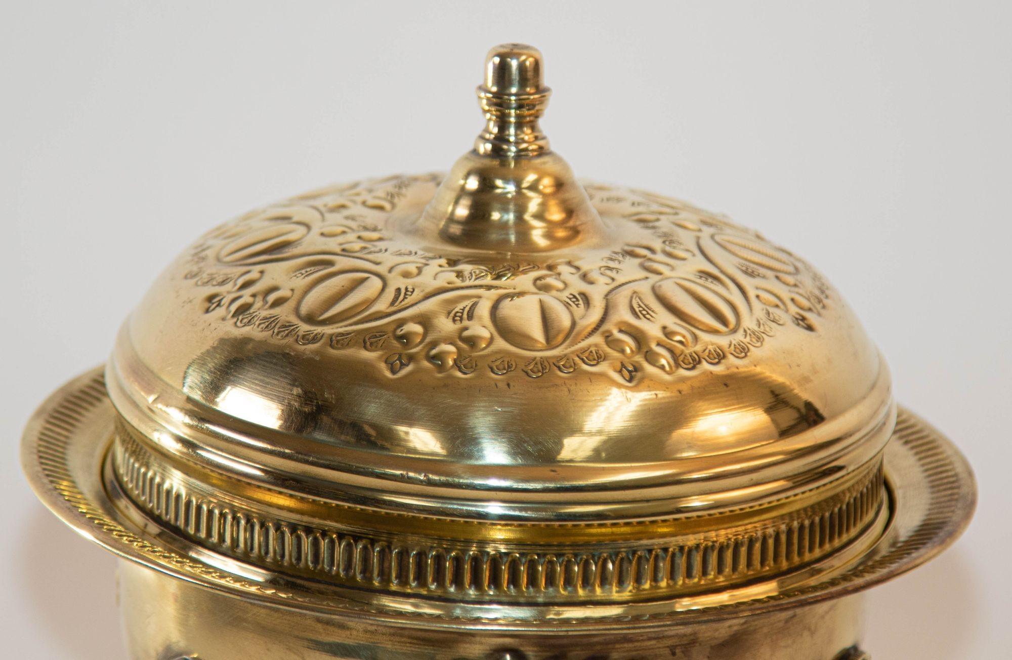 Embossed 1940s Antique Round Moroccan Brass Serving Dish with Dome Lid and Paw Lion Feet. For Sale