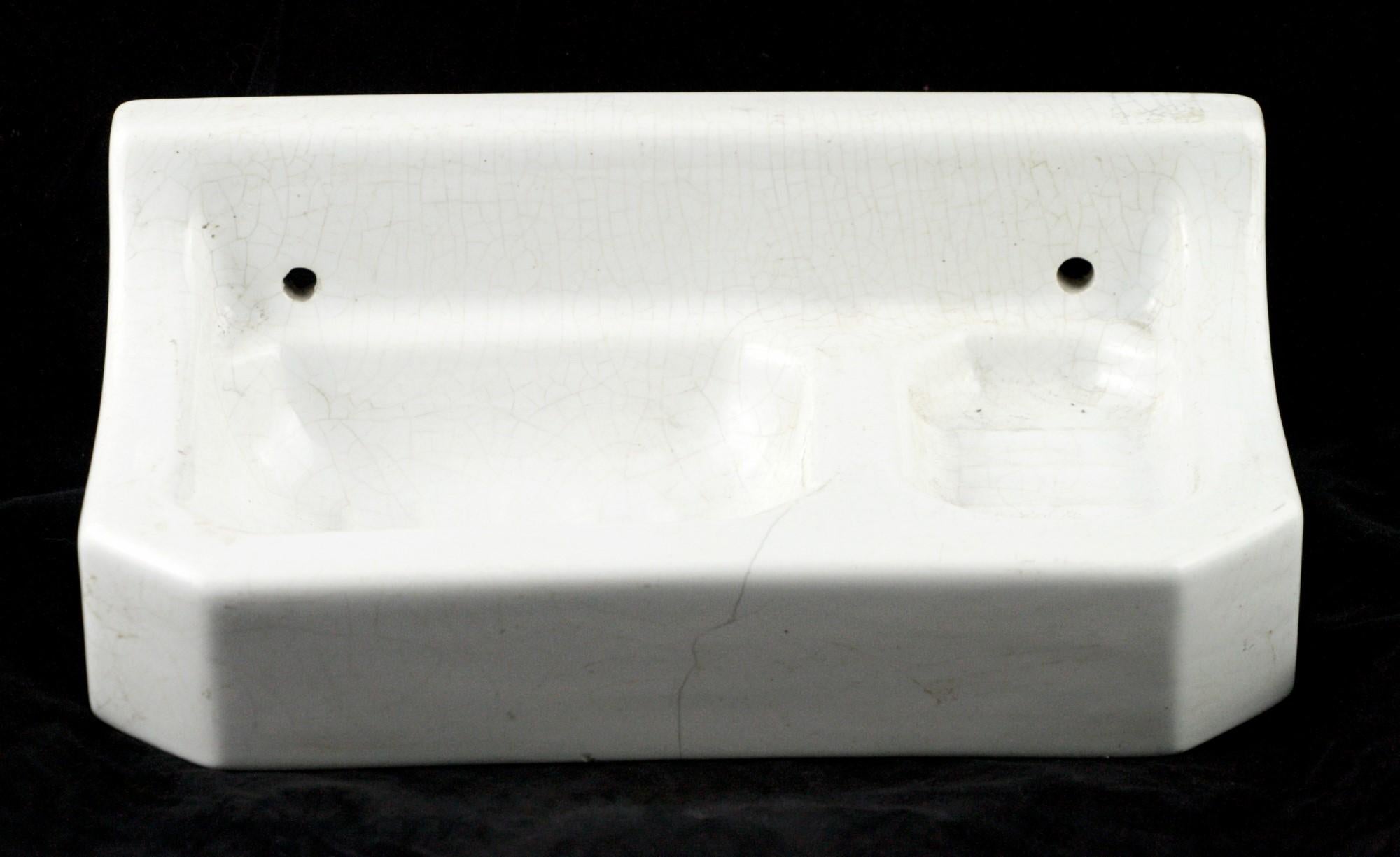 Antique white ceramic French soap and sponge holder with a very desirable slightly crackled glaze. Made to be surface mounted on a wall. From the 1940s. This can be seen at our 400 Gilligan St location in Scranton, PA.