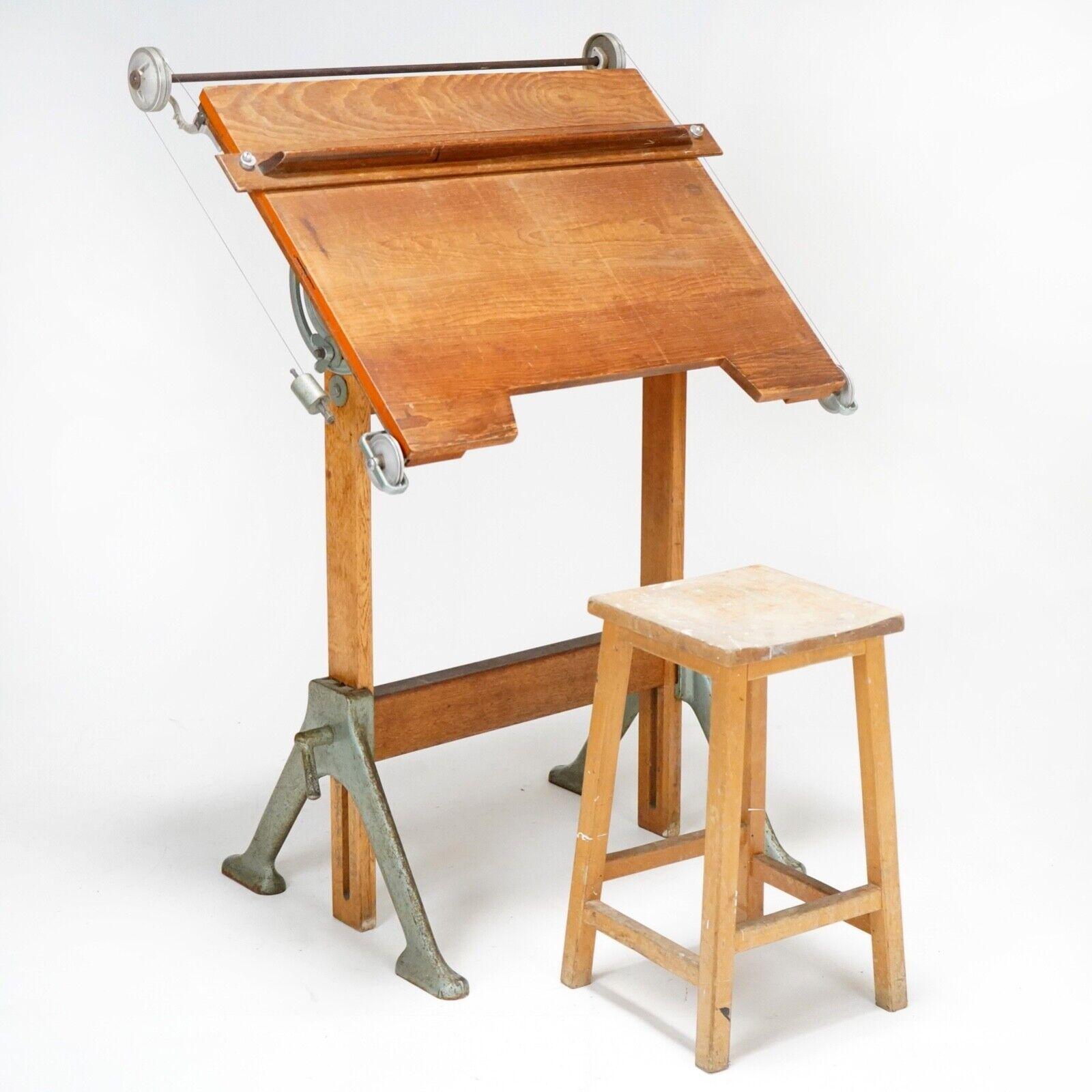 A 1940's Architect's drawing table with cast iron metal base, Beech & Oak frame and top.
 A fully working piece with great pull system. It moves up and down as well as surface tilting and ruler that slides. 
A industrial piece with a elegant look.
