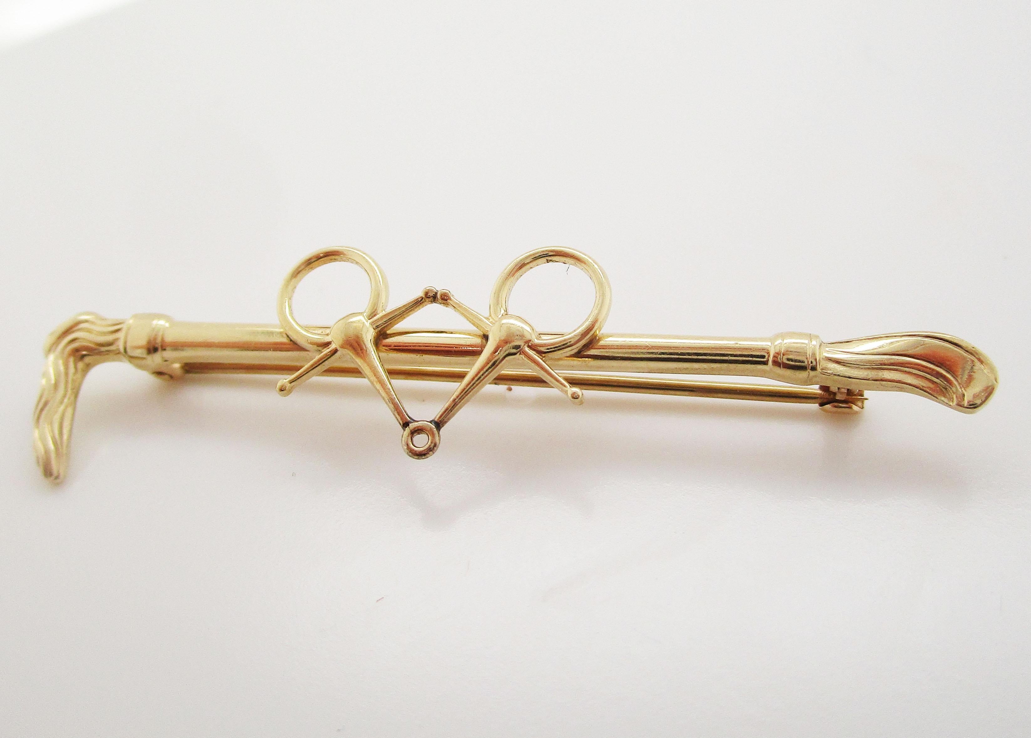 This is a beautiful Art Deco bar or stock pin in 14k yellow gold with a lovely snaffle bit over a riding crop design! This pin is in excellent condition and is the ideal gift for the equine enthusiast that you know. With its dramatic length and