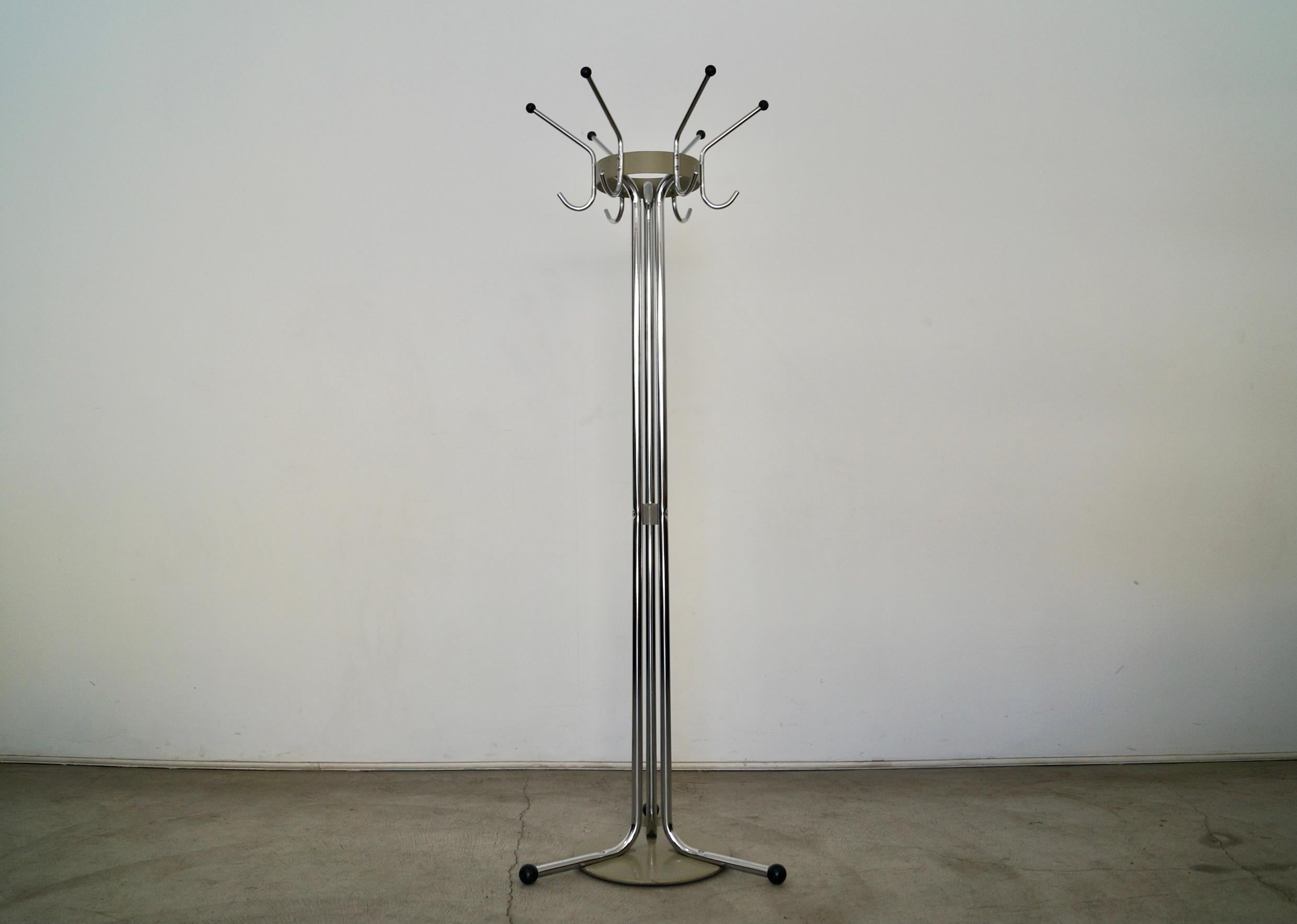 Vintage true Art Deco Mid-century Modern gem for sale. From the 1940's industrial machine age period, and stunning. It's made of thick tubular chrome and metal, and is in incredible condition. It has six hooks for hats, coats, bags, and umbrellas.