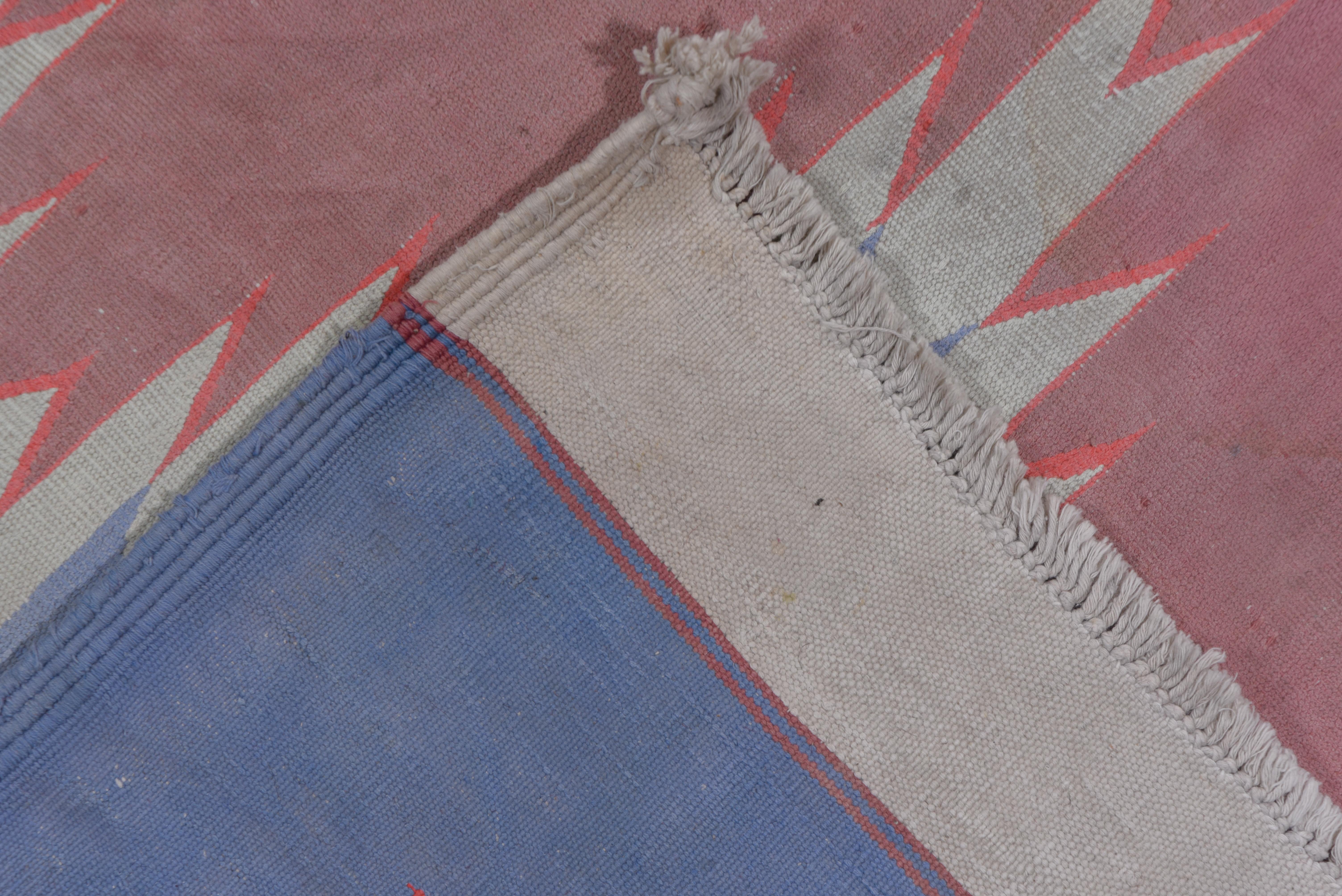 Two columns of plain coral flattened ashiks decorate the gray field with smaller blue ashiks between. Sharply serrated mid-blue border with irregularities on one side. All-cotton construction. Wide white plain weave end strips beyond the border.