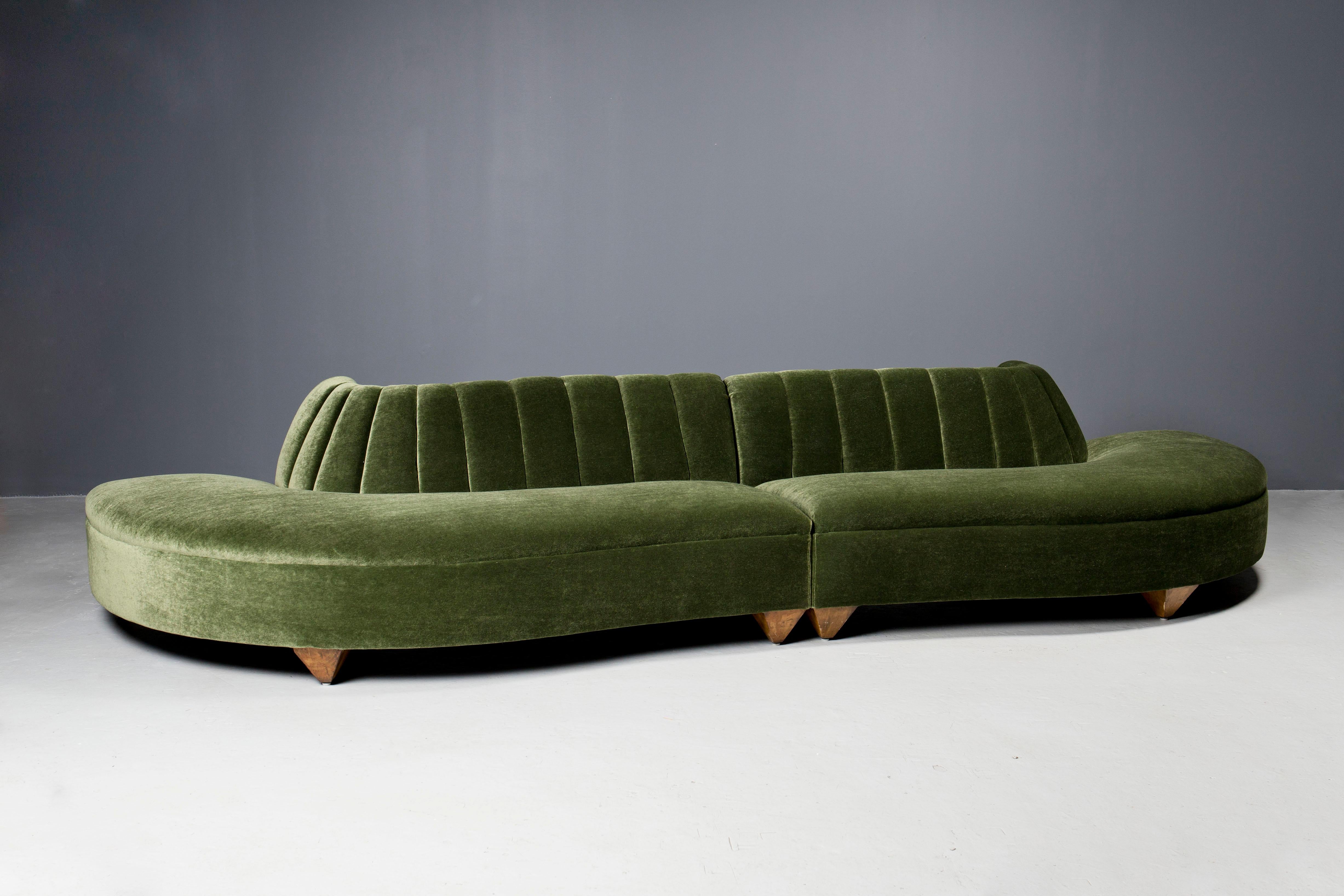 Impressive, sculptural  Art Deco couch, in two parts, newly upholstered in moss mohair with reversed pyramid wooden legs and channeled back.
This couch has been completely restored with new springs, webbing and foam, providing ultimate comfort and