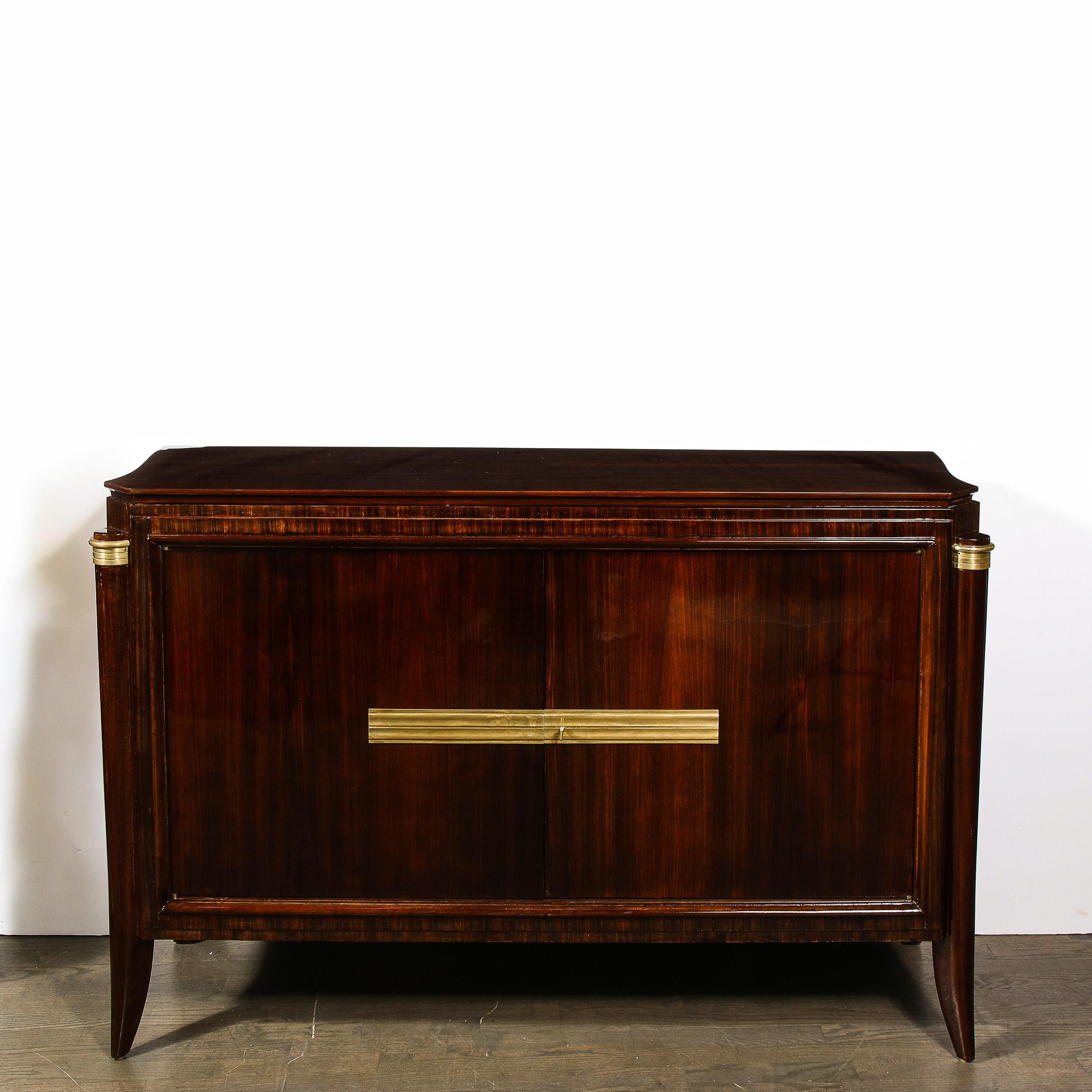 This elegant Art Deco Directoire style sideboard was realized in France, circa 1940. It features cabriolet legs capped with streamlined bronzed and a volumetric rectangular body in bookmatched walnut with a channeled bronzed placket complete with