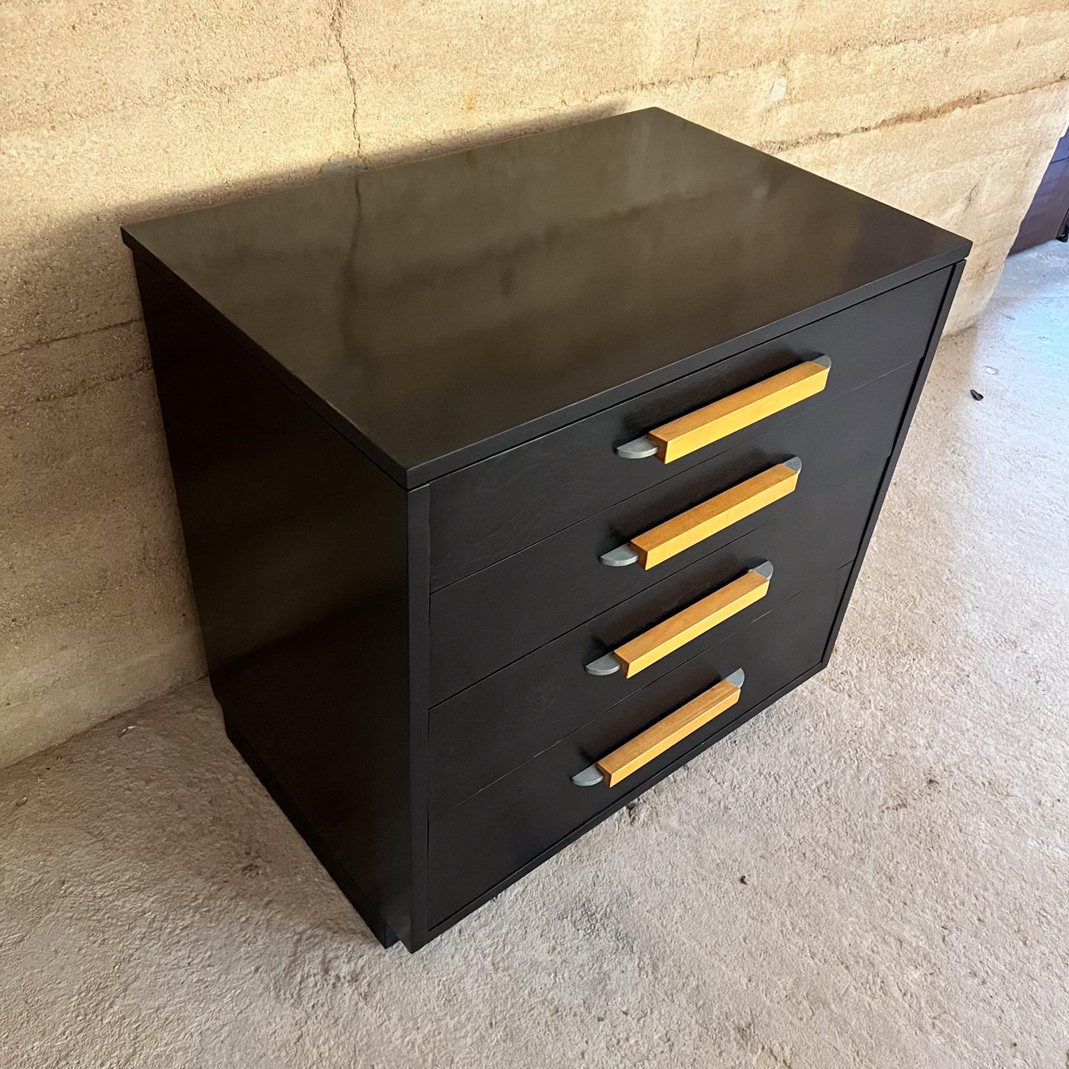 Midcentury modern dresser designed by Eliel Saarinen Johnson Furniture Co. Ebonized oakwood mahogany base.
Dresser for FHA collection 
Primavera wood handles in solid wood sculptural aluminum.
Double dove tail joinery. 
30 w x 30 h X 20 d
No label