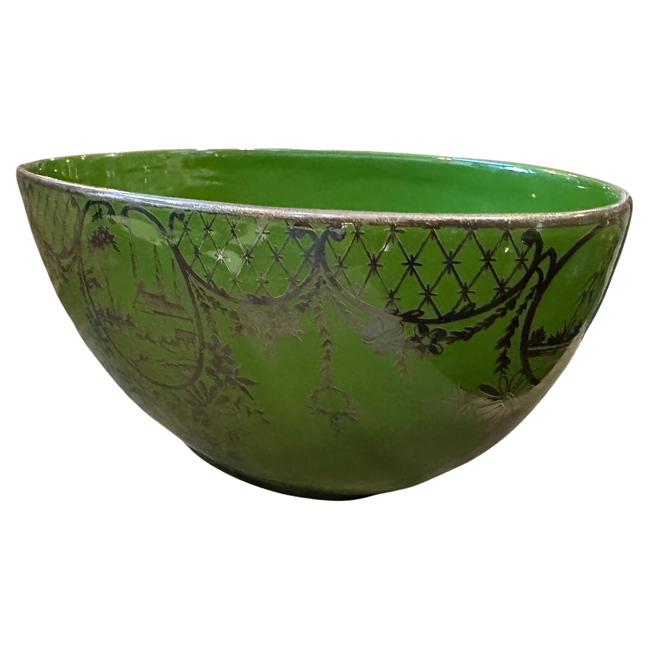 An Art Deco Green Ceramic and Silver Oval Centerpiece manufactured in Italy in the Forties, oval-shaped ceramic in a shade of green with a glazed finish and sterling silver decors. The use of green ceramic and silver creates an elegant contrast, and