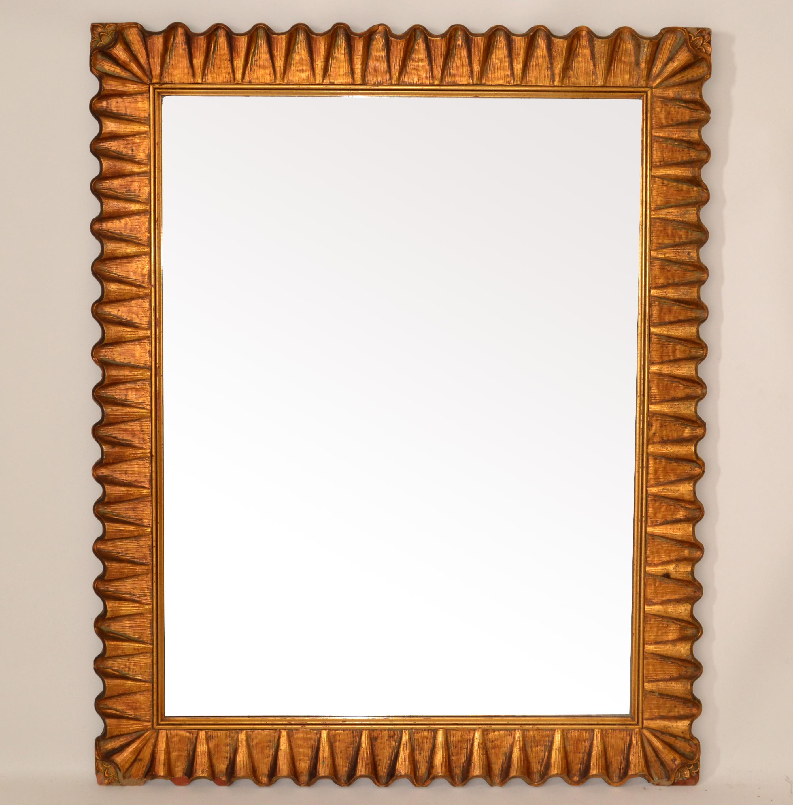 1940s hand-carved Art Deco scalloped rectangle Wall Mirror in Gilt Wood made in America.
In all original condition with some losses to one corner and scuffs due to History and use and foxing to the Mirror Glass.
Mirror Size: 33.25 x 25.5 inches.