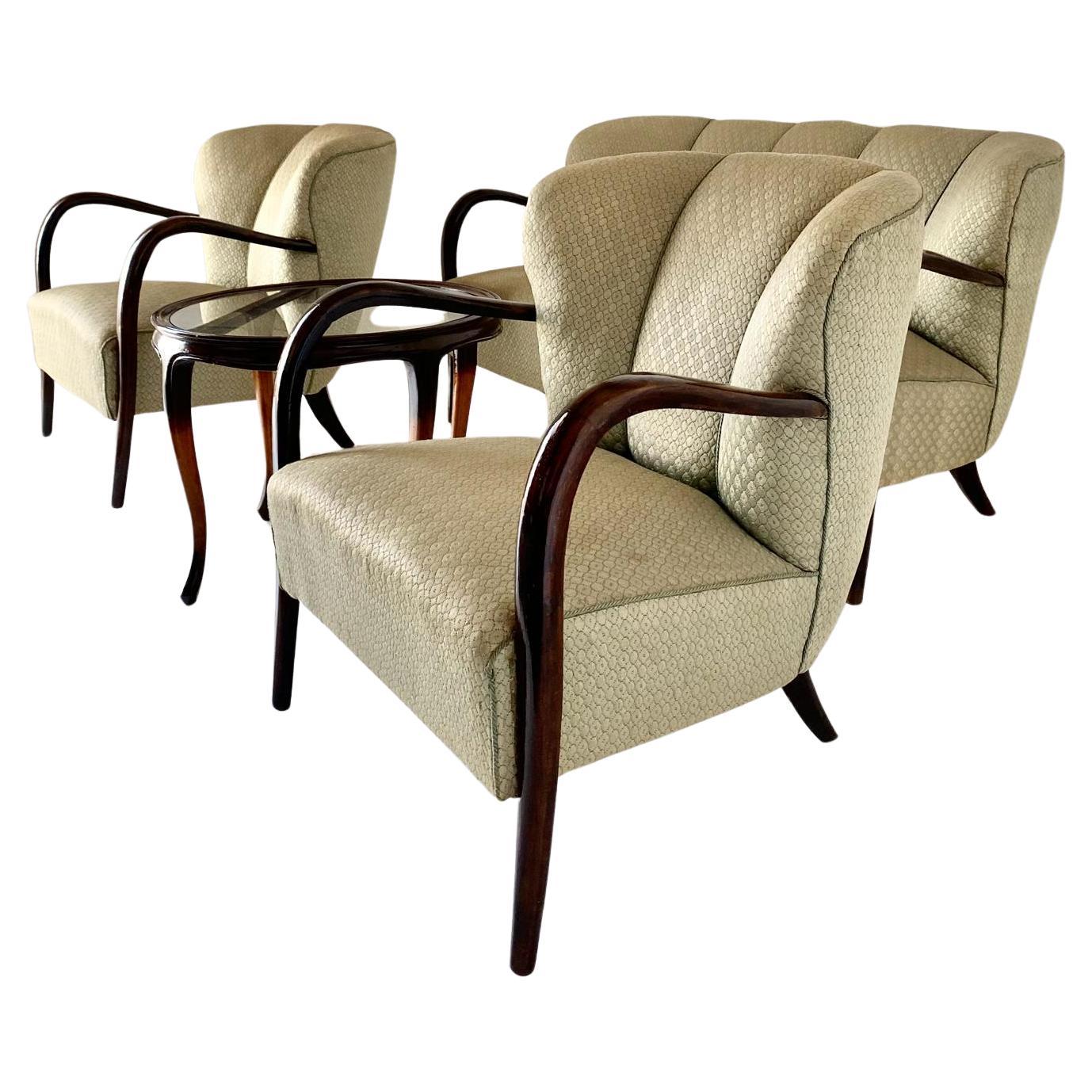 A rare 1950s Art Deco style living room set by Malatesta and Mason. Beautifully made in Italy, the set consists of two armchairs and a two-seater sofa and a curved solid wood coffee table with glass top. Both the armchairs and the sofa still have