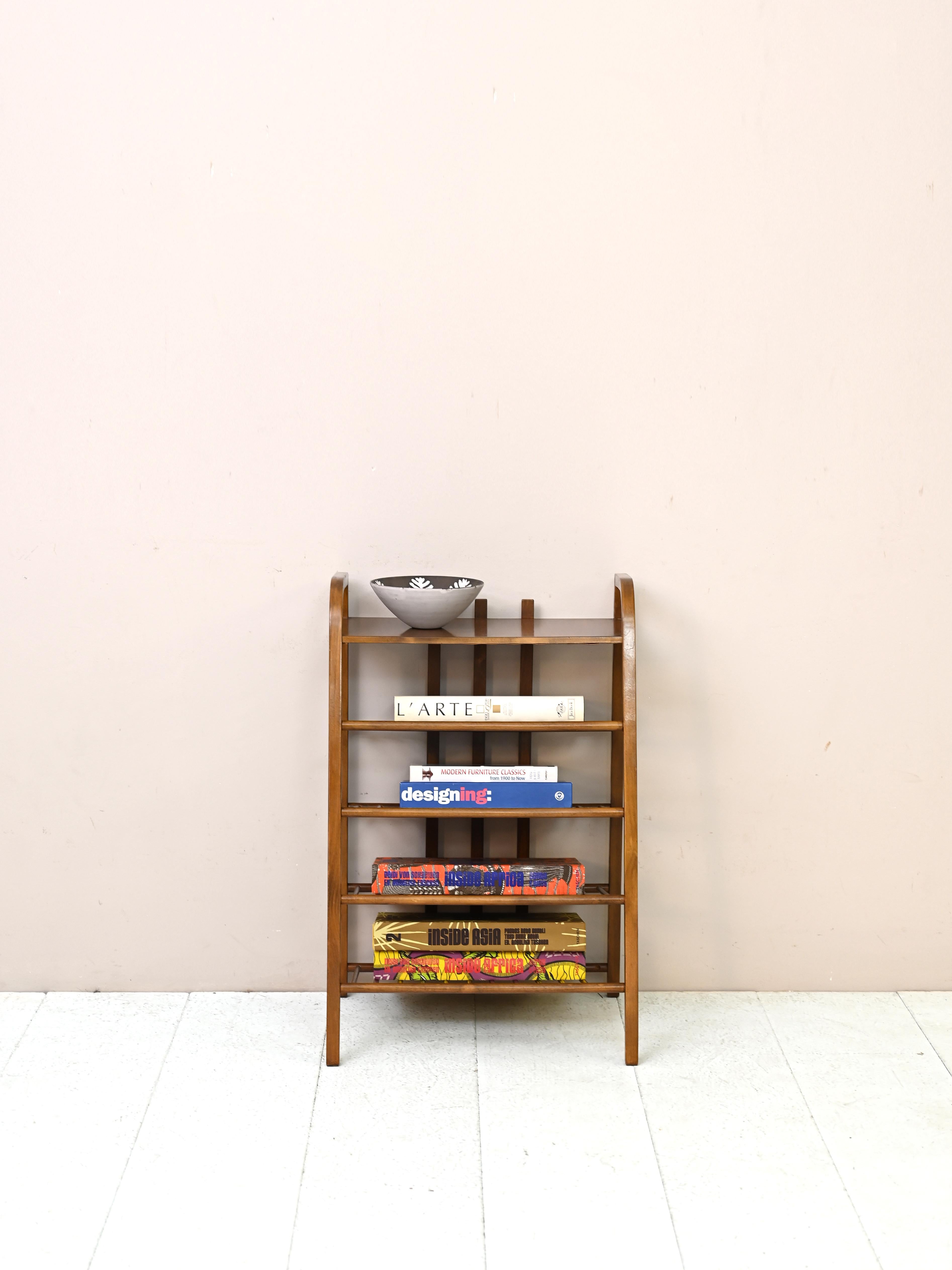 Wooden magazine rack designed in the 1940s Art Deco with soft, elegant lines and three shelves.

Good condition. It has been restored with natural products. It may show some signs
of time. Please pay attention to the photographs.

AC492
