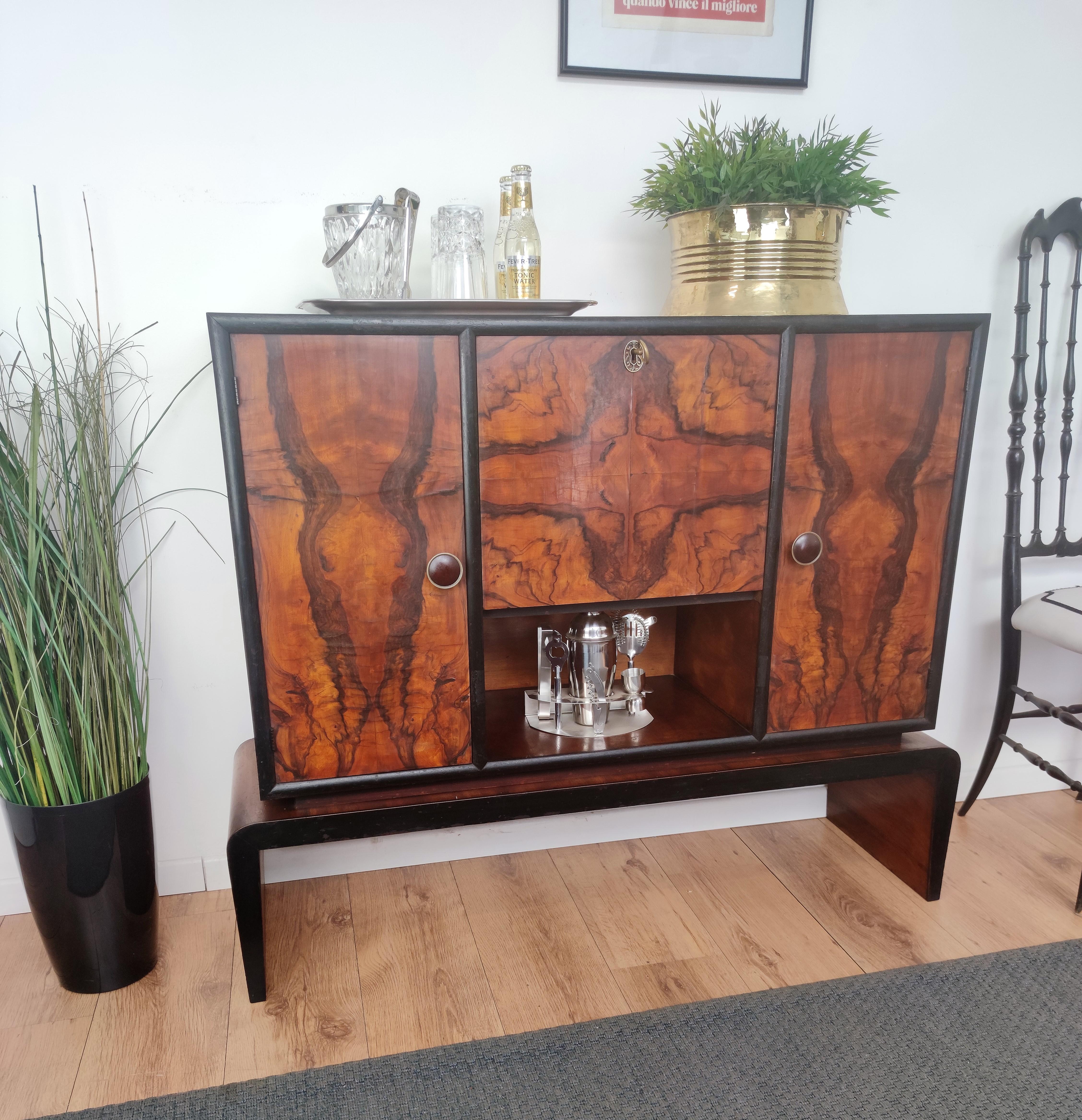 Very elegant Italian Art Deco Mid-Century Modern dry bar cabinet, in beautiful veneer walnut briar burl wood, two side doors with shelves and central flip door with interior part in mirror and antique brass keylock. The unique and typical design,