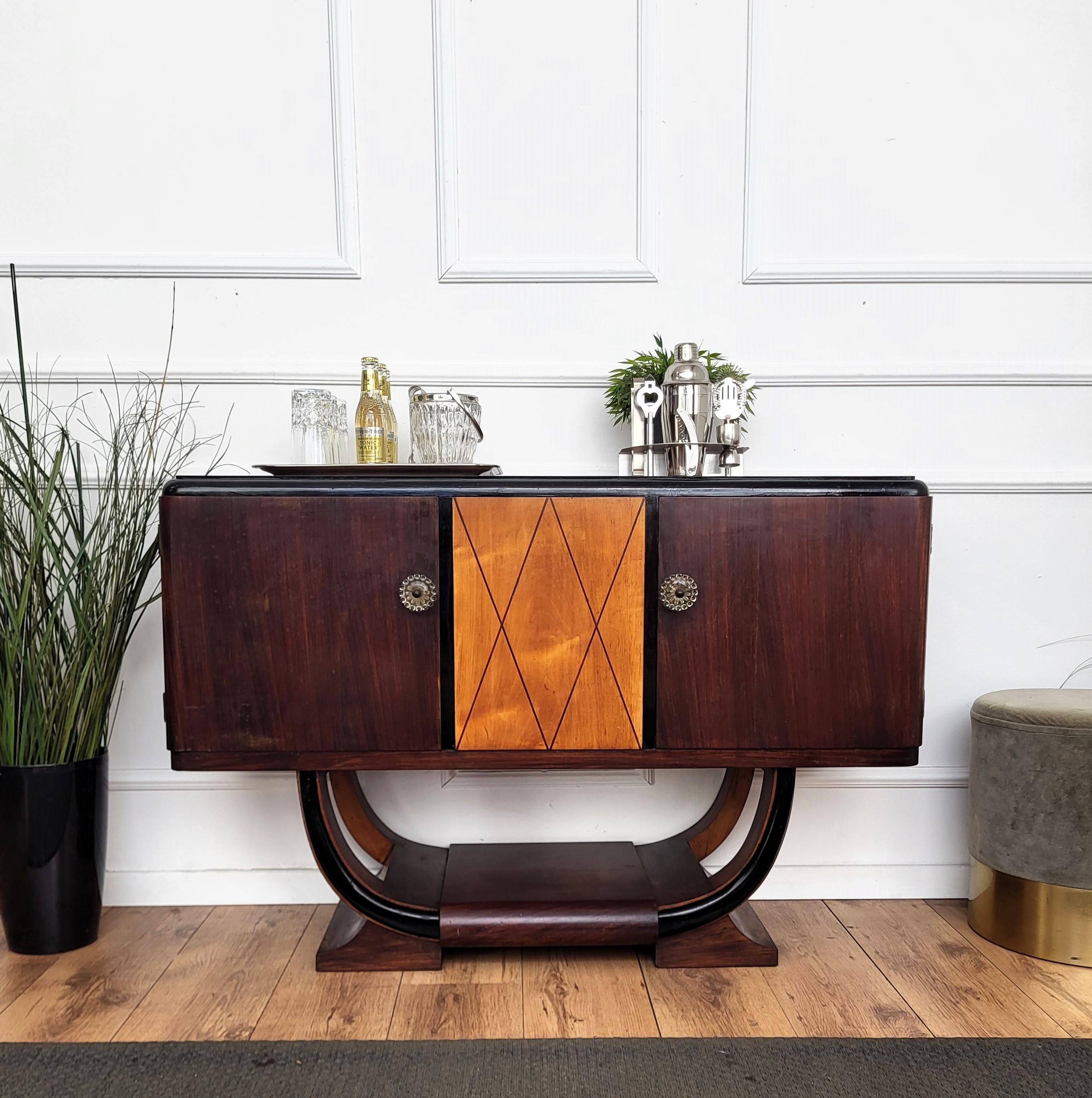 Unique and very elegant Italian Art Deco Mid-Century Modern dry bar cabinet, in beautiful veneer walnut wood, with two side doors, central wood decor and antique handles. The unique and typical design and shapes make this a true statement piece in