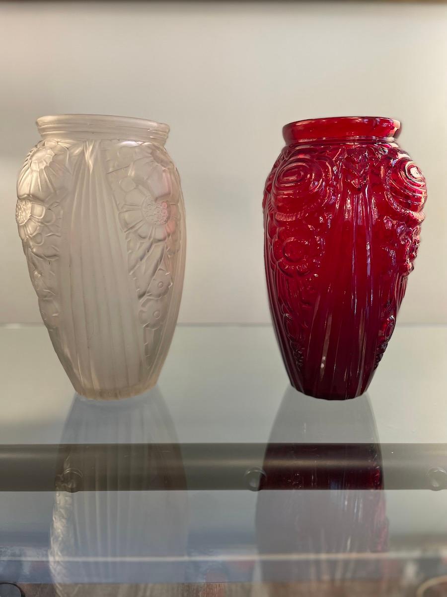 1940s Art Deco Red and Opal White Art Glass Vases. The glass decoration images are referred to flowers and leaf decoration. The vases are selling separately, one is realized in red glass, while the other one is made with opal glass. 
