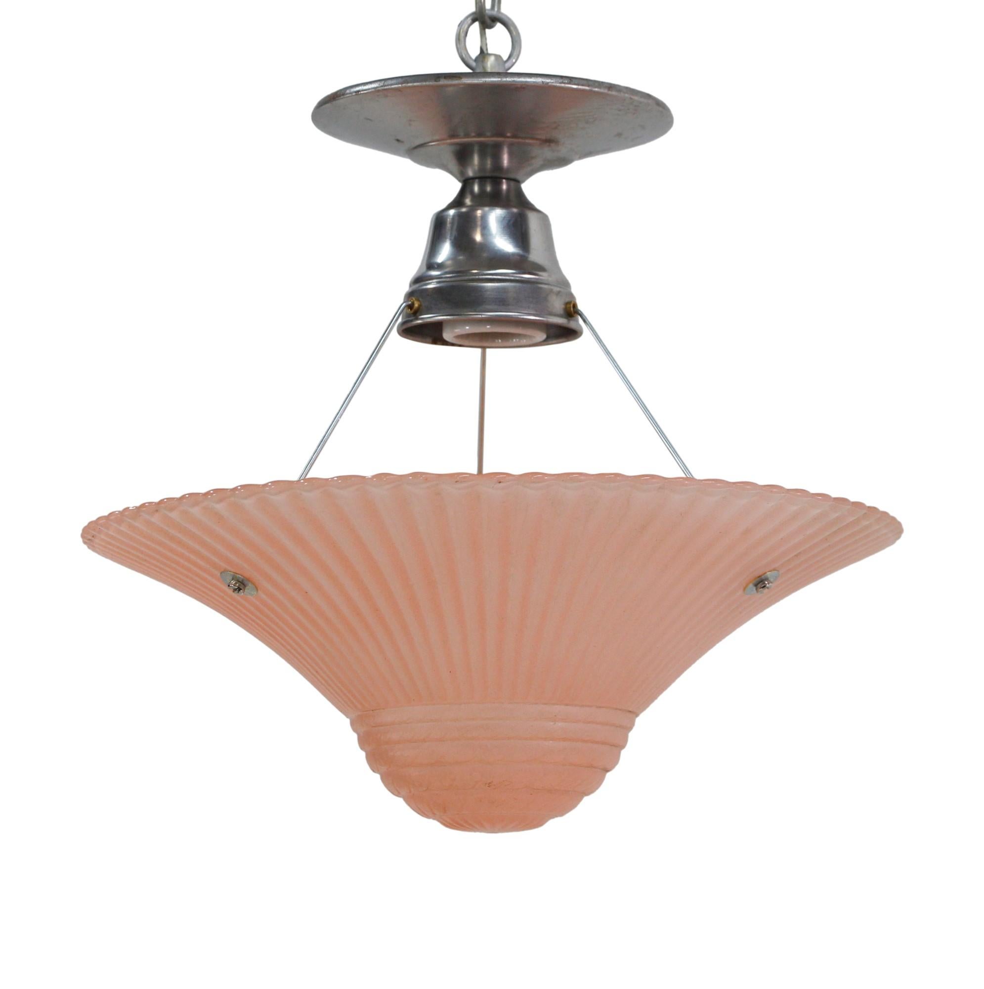 Art Deco flared pink glass dome shade with chrome flush mount base.  The chrome fitter has one porcelain socket with three polls supporting the shade. Price includes restoration. This can be seen at our 400 Gilligan St location in Scranton, PA.