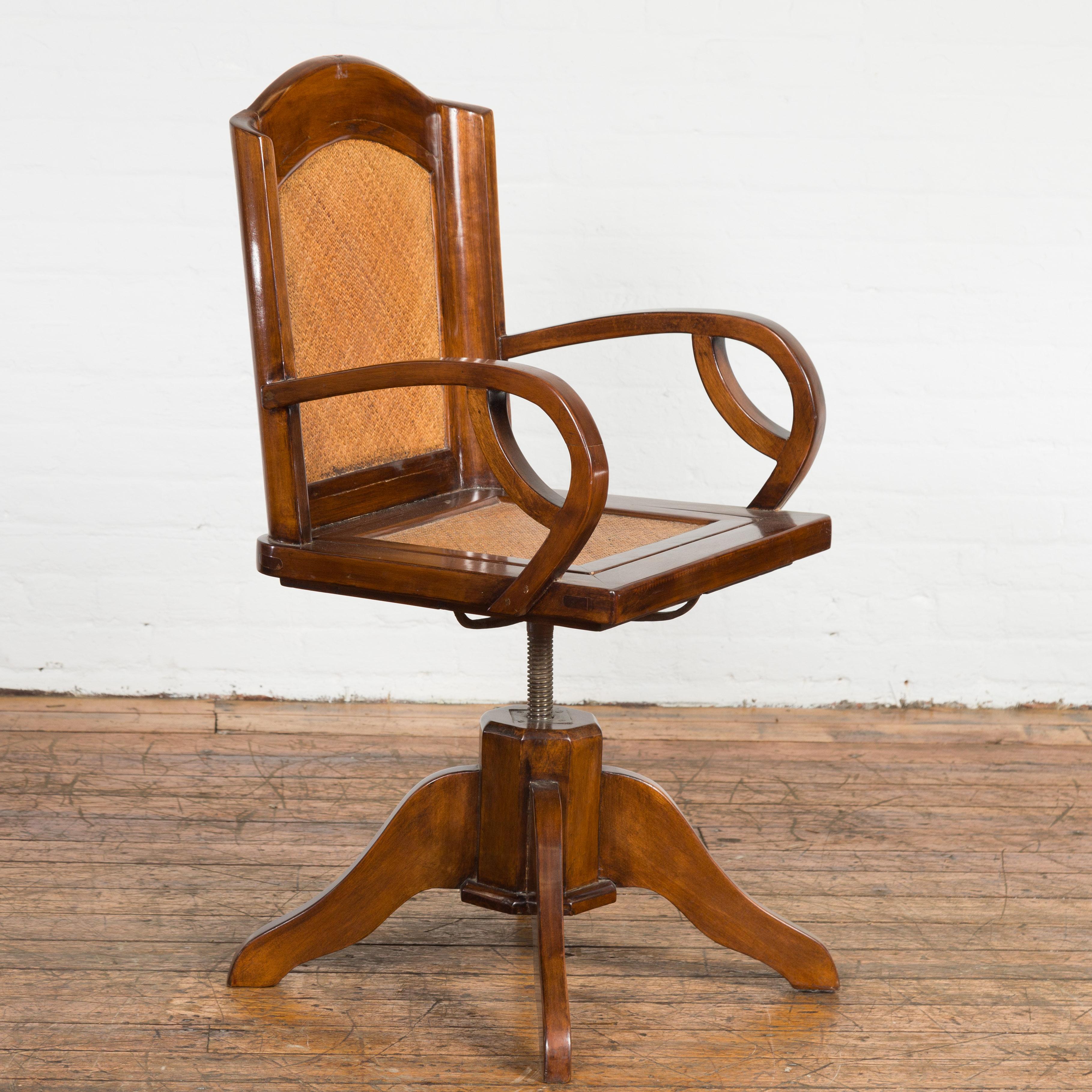 Carved 1940s Art Deco Style Swivel Desk Chair with Woven Rattan and Loop Arms For Sale
