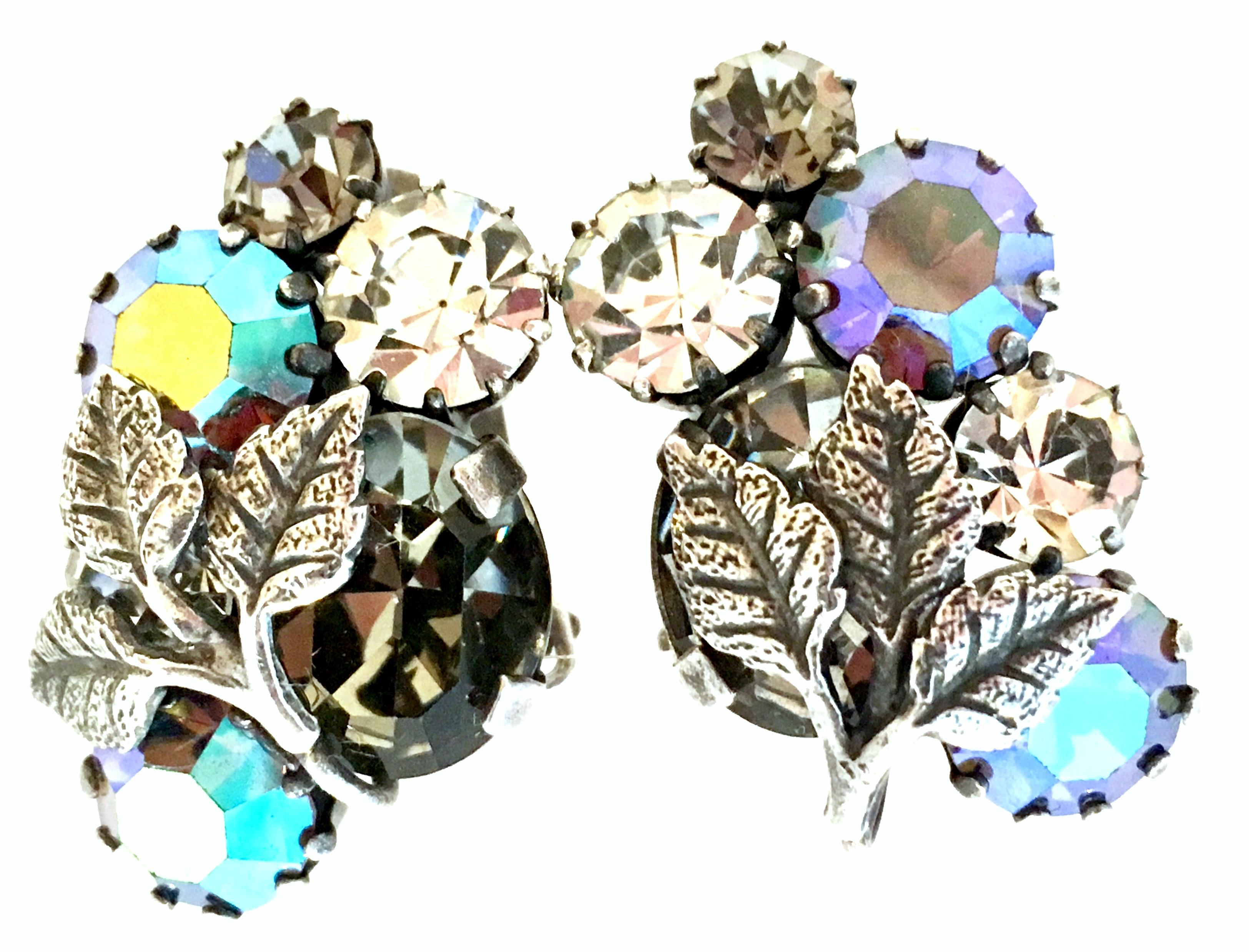 Vintage Austrian Silver Plate & Austrian Crystal Rhinestone clip earrings. Features a beautiful silver leaf detail with prong set, blue aurora borealis, clear and smoky topaz Austrian crystal rhinestones. Each piece is signed on the underside, Made