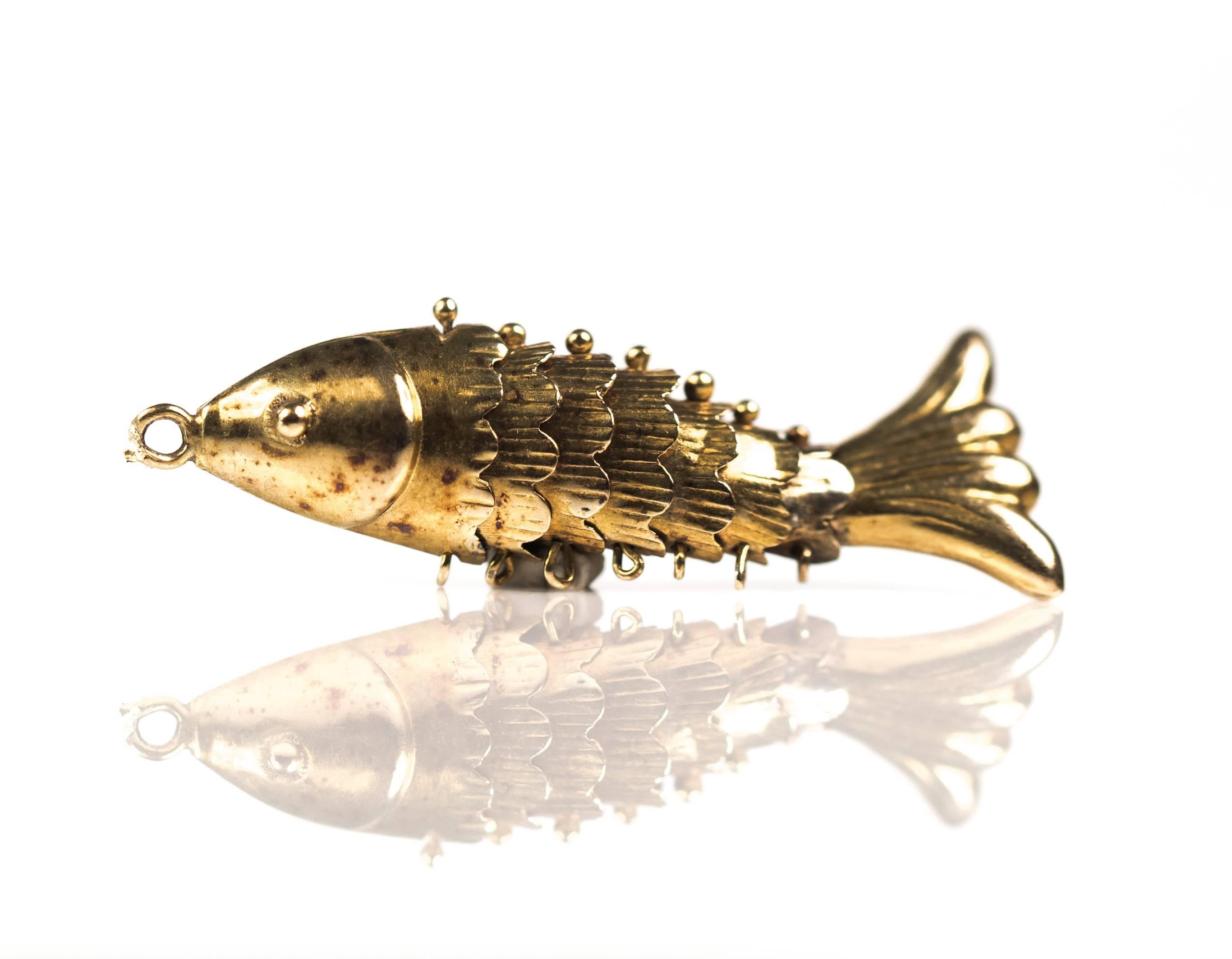 1940s Articulated Fish Charm - 14 Karat Yellow Gold 

Features 8 individual sections and stunning detail. This 14 Karat Yellow Koi Fish has 8 articulated sections. The head is followed by 6 scale segments which finish with the flowing tail segment.