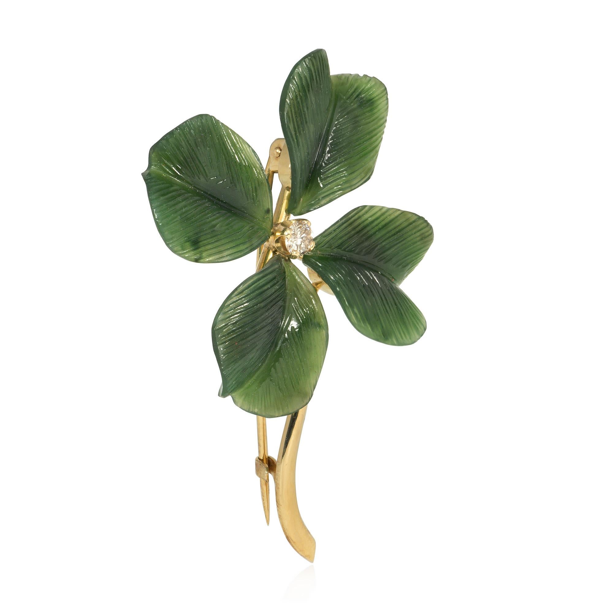 A Retro period gold and carved nephrite jade brooch in the form of a four leaf clover with a diamond center and gold stem, in 14k. Austria

Jade is often associated with nobility and wealth, and symbolizes harmony and balance. This is a highly