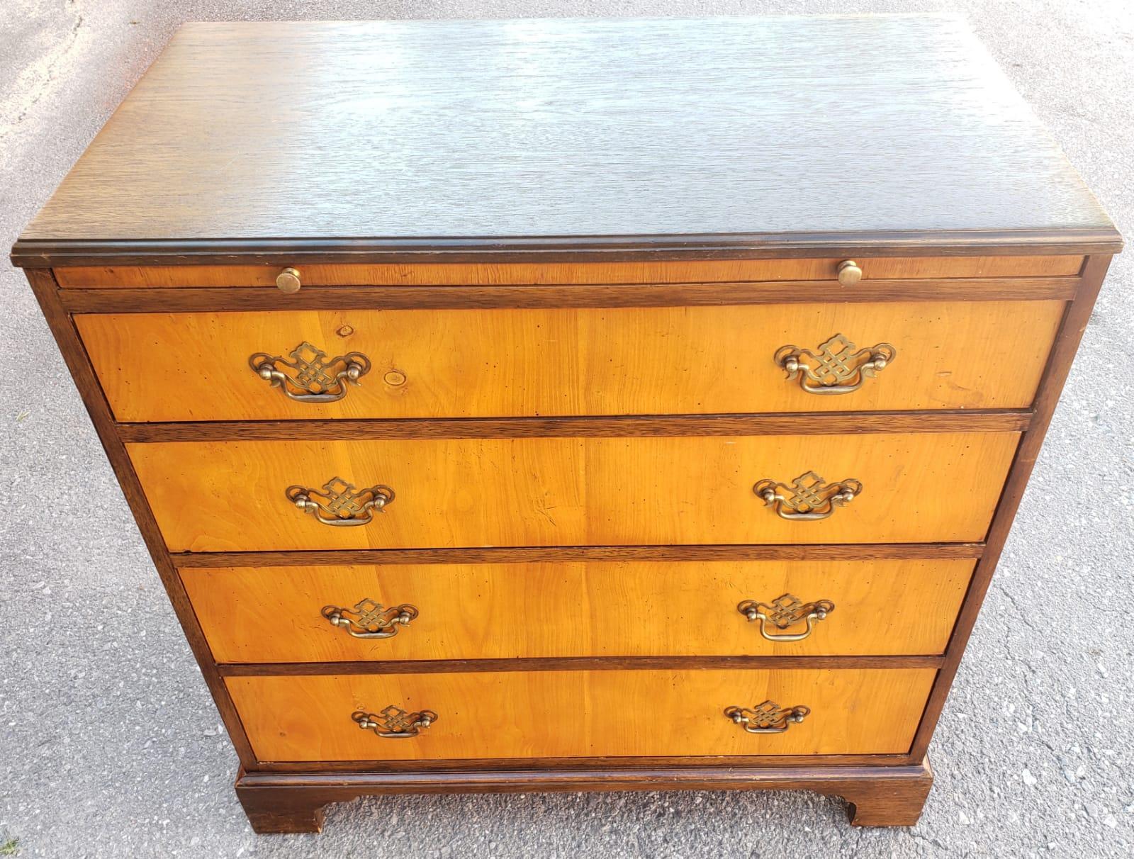 Rare 1940s Vintage Baker Furniture Satinwood and Walnut Chest With Pull Out Tray. Features 4 dovetailed drawers in smooth working condition. Comes with original hardware. Dark walnut sides and top. Satinwood front. Very good condition.
Measures