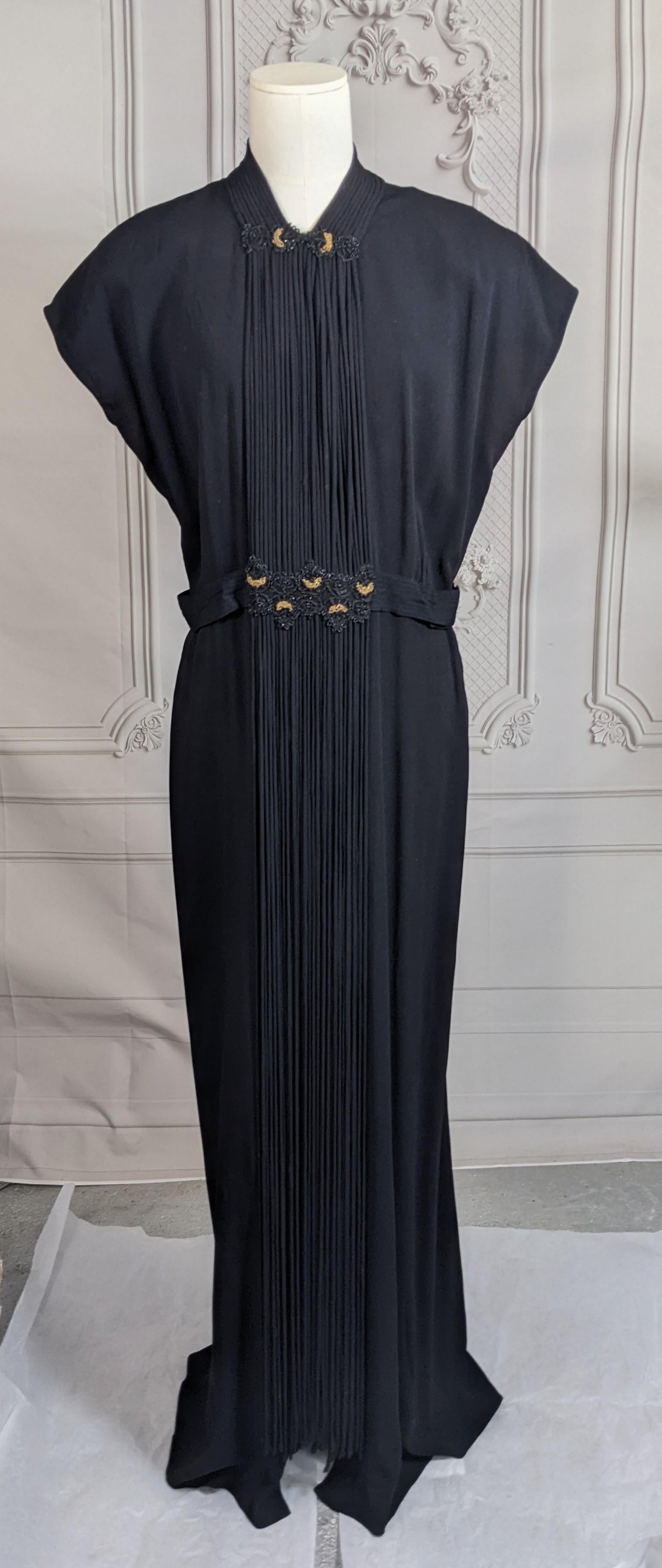Elegant Beaded Crepe and Self Fabric Bias Rope Trimmed Gown from the 1940's. Beautiful and Unusual design with yards of crepe bias rope used as self trim. A cascade of these ropes travel from the neckline down chest and dangle free to floor. At neck