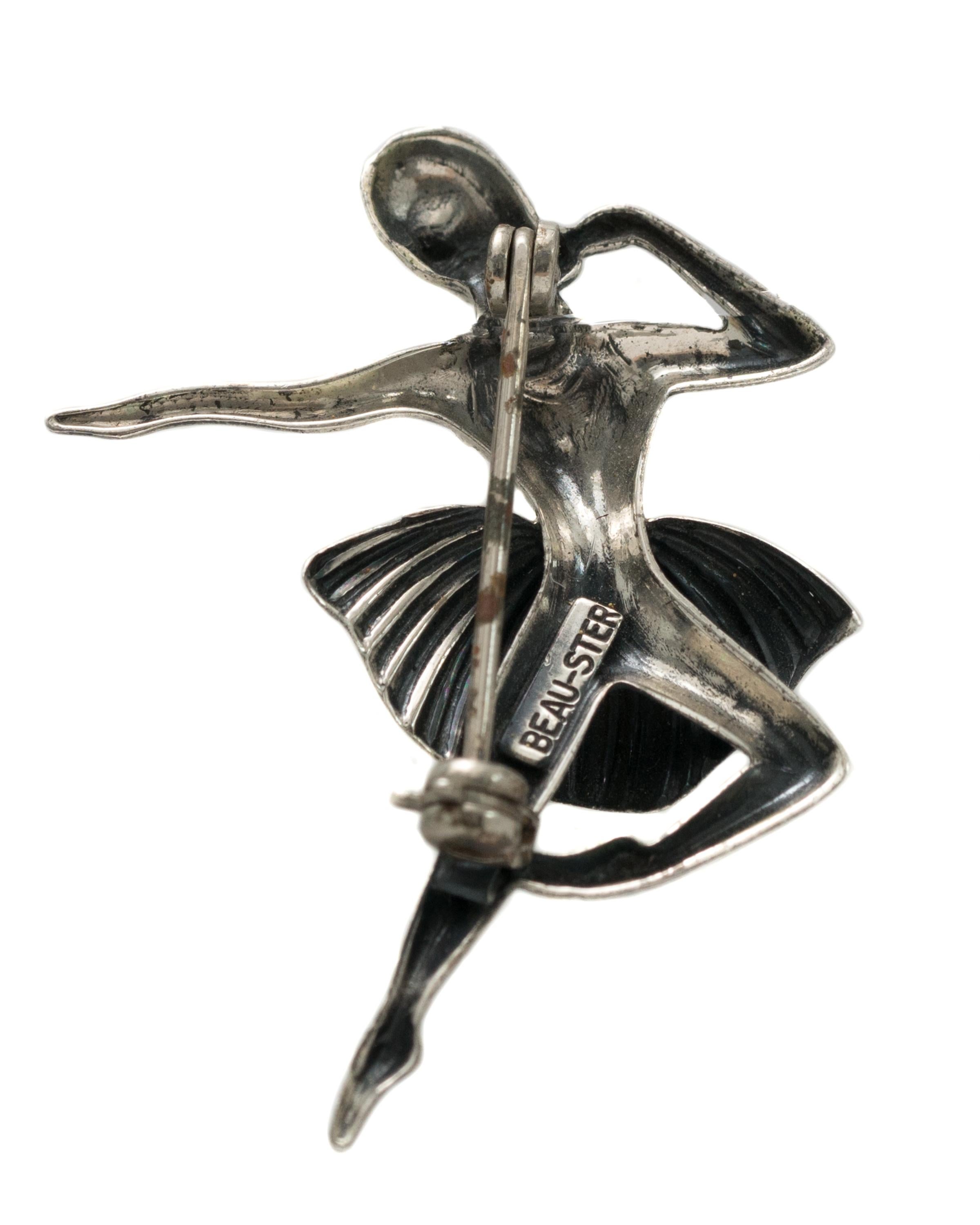 Rare, Collectible 1940s Retro Ballerina Pin - Sterling Silver 

Features:
A tiny dancer wearing pointe shoes and a tutu. The tutu is textured and curved creating the illusion of movement. 
The brooch has graceful lines, is lightweight and has a