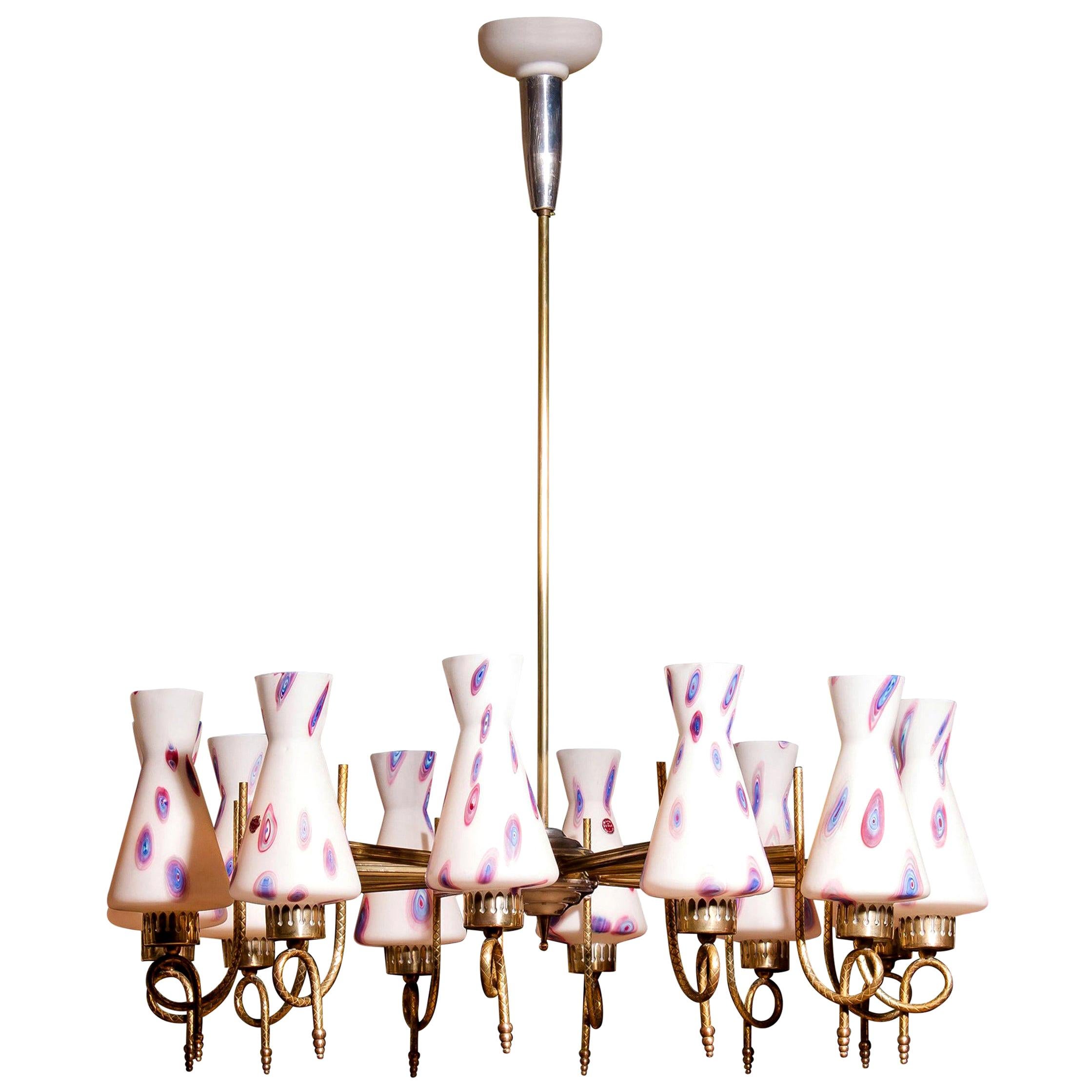 Magnificent large chandelier.
This lamp is made of a beautiful brass with polished aluminum shape with twelve white designed Murano glass shades and made by Stilnovo.
Dimensions: H 90 cm, ø 80 cm.
Technically 100%.