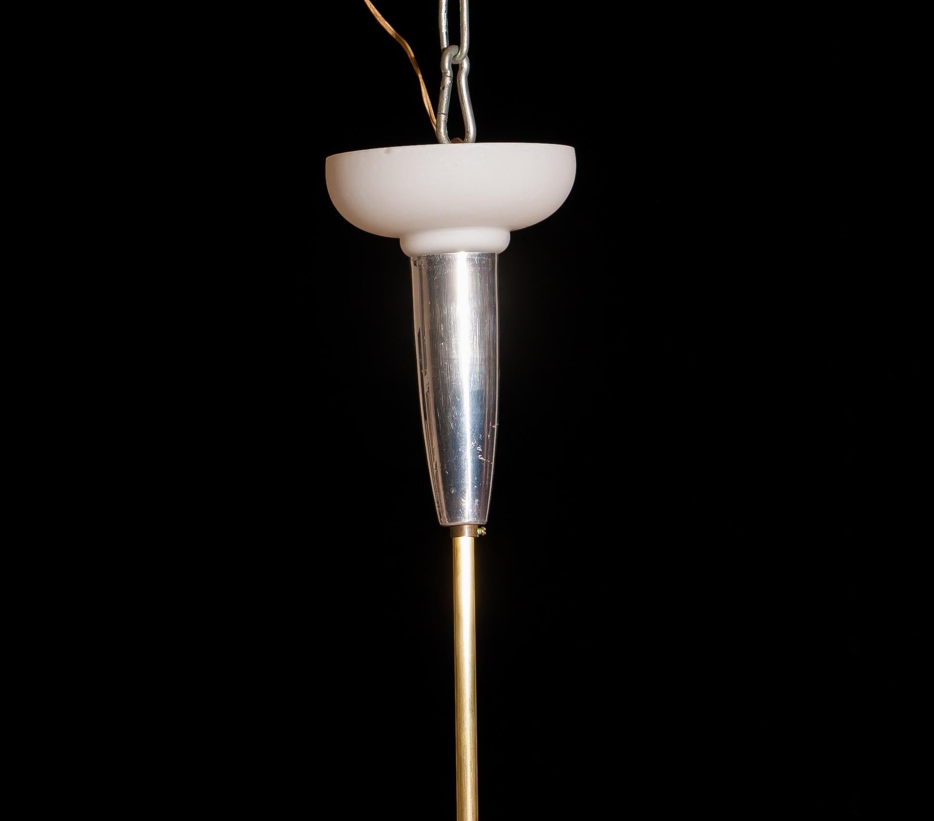 Magnificent large chandelier.
This lamp is made of a beautiful brass with polished aluminium shape with twelve white designed Murano glass shades.
The shades are labelled.
It is in an excellent working condition.
Period 1940s
Dimensions: H 90