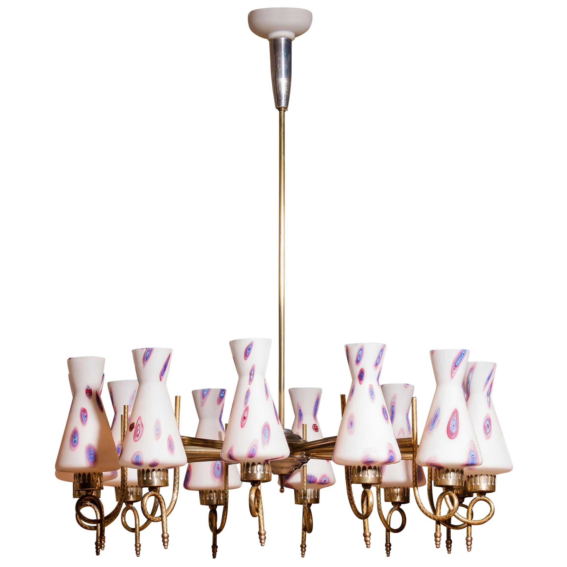 Magnificent large chandelier.
This lamp is made of a beautiful brass with polished aluminium shape with twelve white designed Murano glass shades.
The shades are labelled.
It is in an excellent working condition.
Period 1940s.
Dimensions: H 90