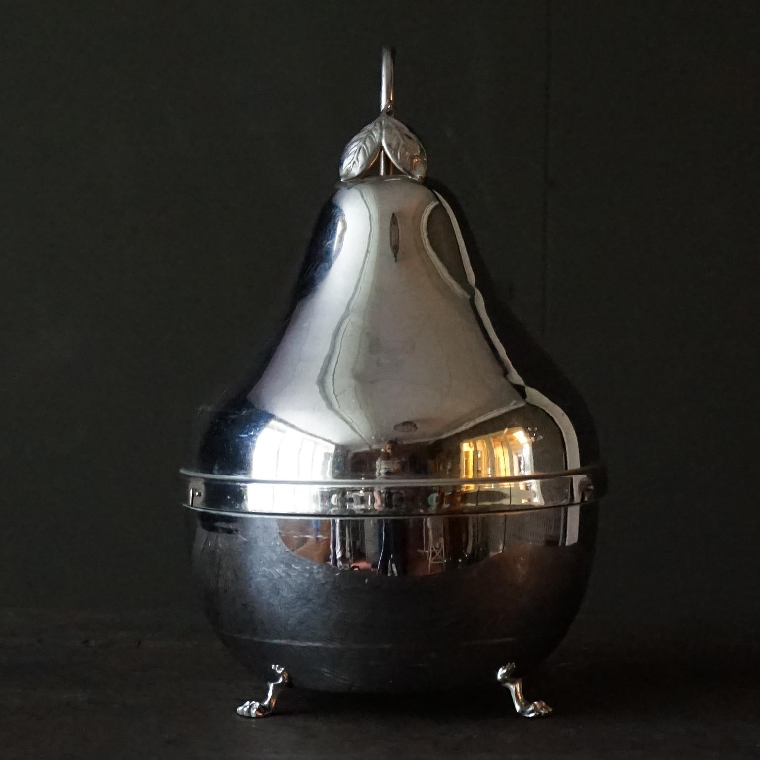 Pretty 1940s Belgian Mid Century Modern pear shaped stainless steel liquor cellar with a CVC Belgium Art-Deco uranium (or vaseline) glass carafe and 6 coloured glasses inside
The holder is removable so in the bottom half of the pear you could easily