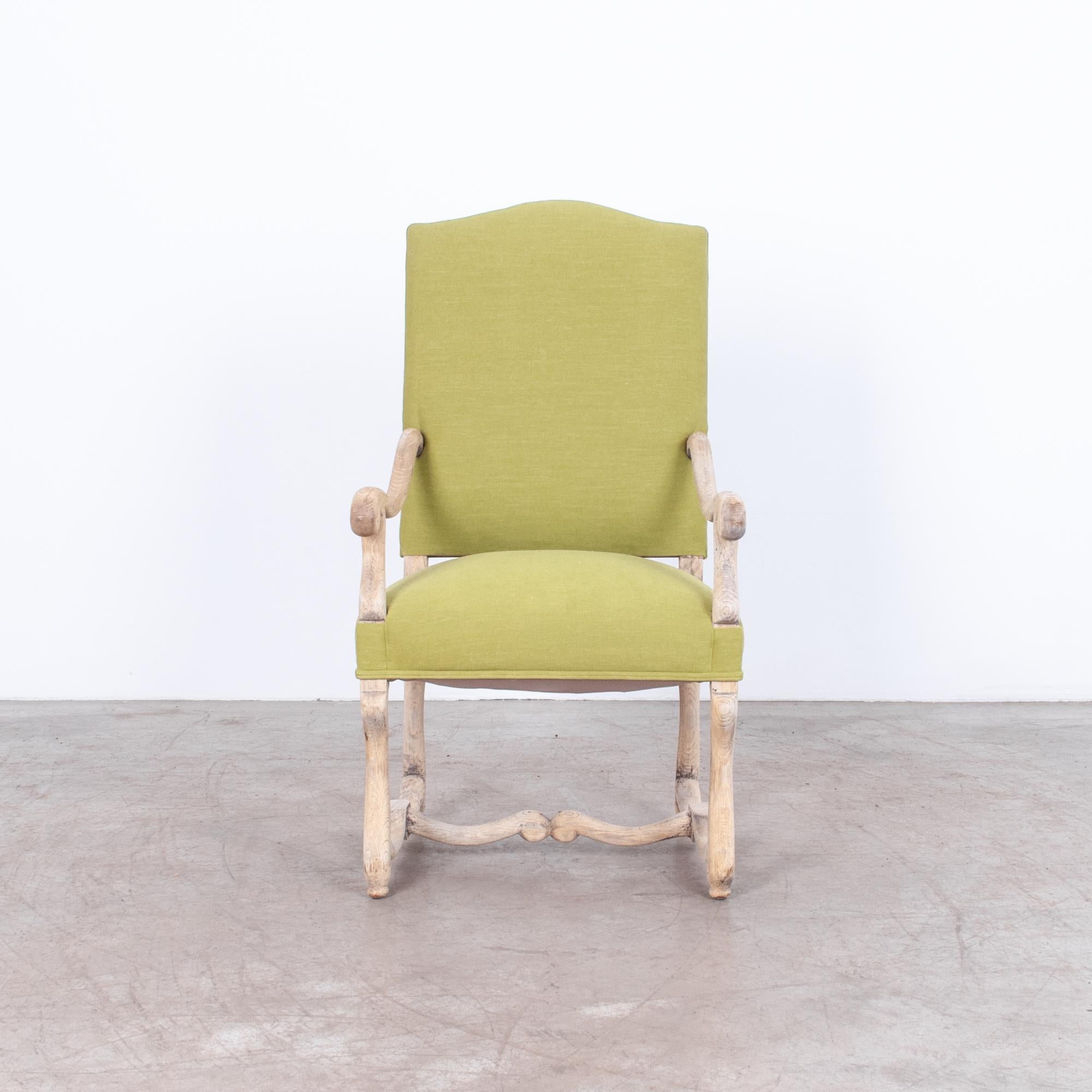 Ornate upholstered armchair from Belgium, circa 1940. A distinctive “os de mouton” shape, called after the “bone of the sheep,” in naturally finished oak. With a striking green updated upholstery, this chair is fitted for contemporary interiors,