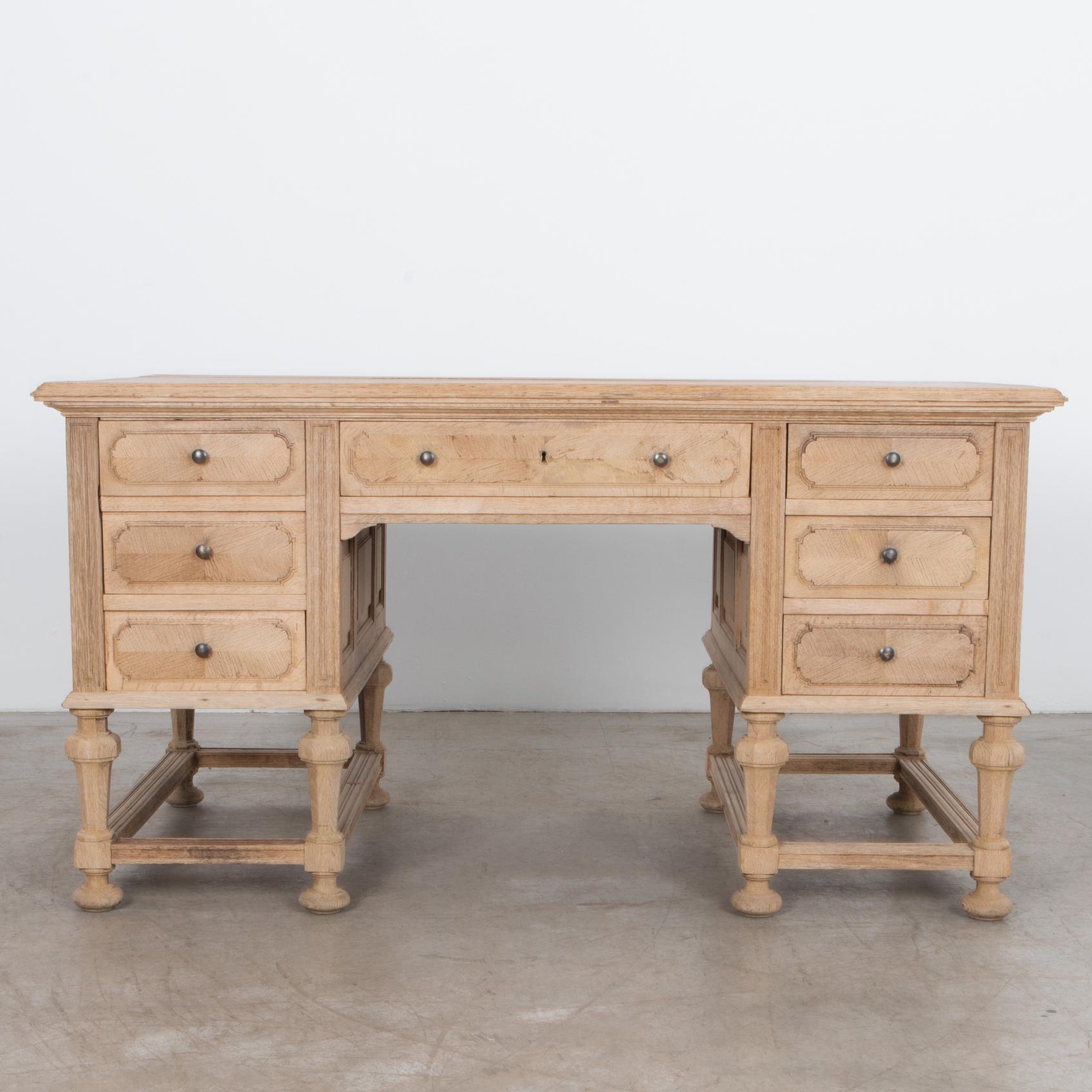 From circa 1940, this desk features plenty of drawer storage, an elegant
traditional construction with natural wood top, resting on stable carved legs. An
oil finish highlights the aesthetic qualities of the oak, and the charming