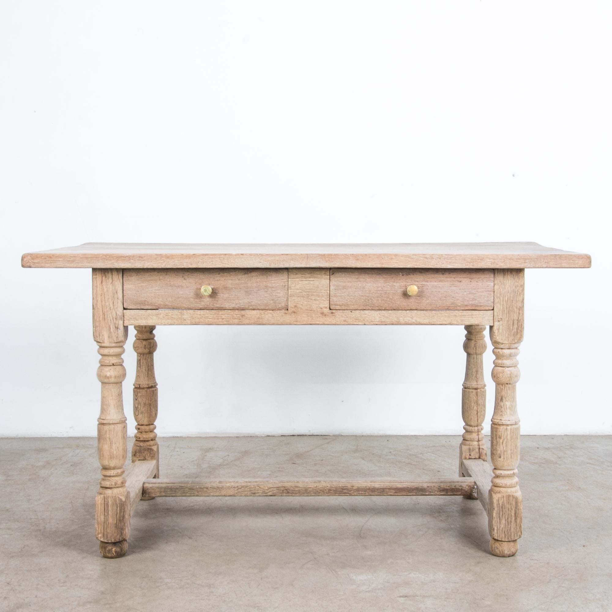 Rustic and simple Belgian style farmhouse table from the 1960s in bleached oak. A sturdy construction follows the lineage of European craftsmanship. Equipped with two practical drawers.