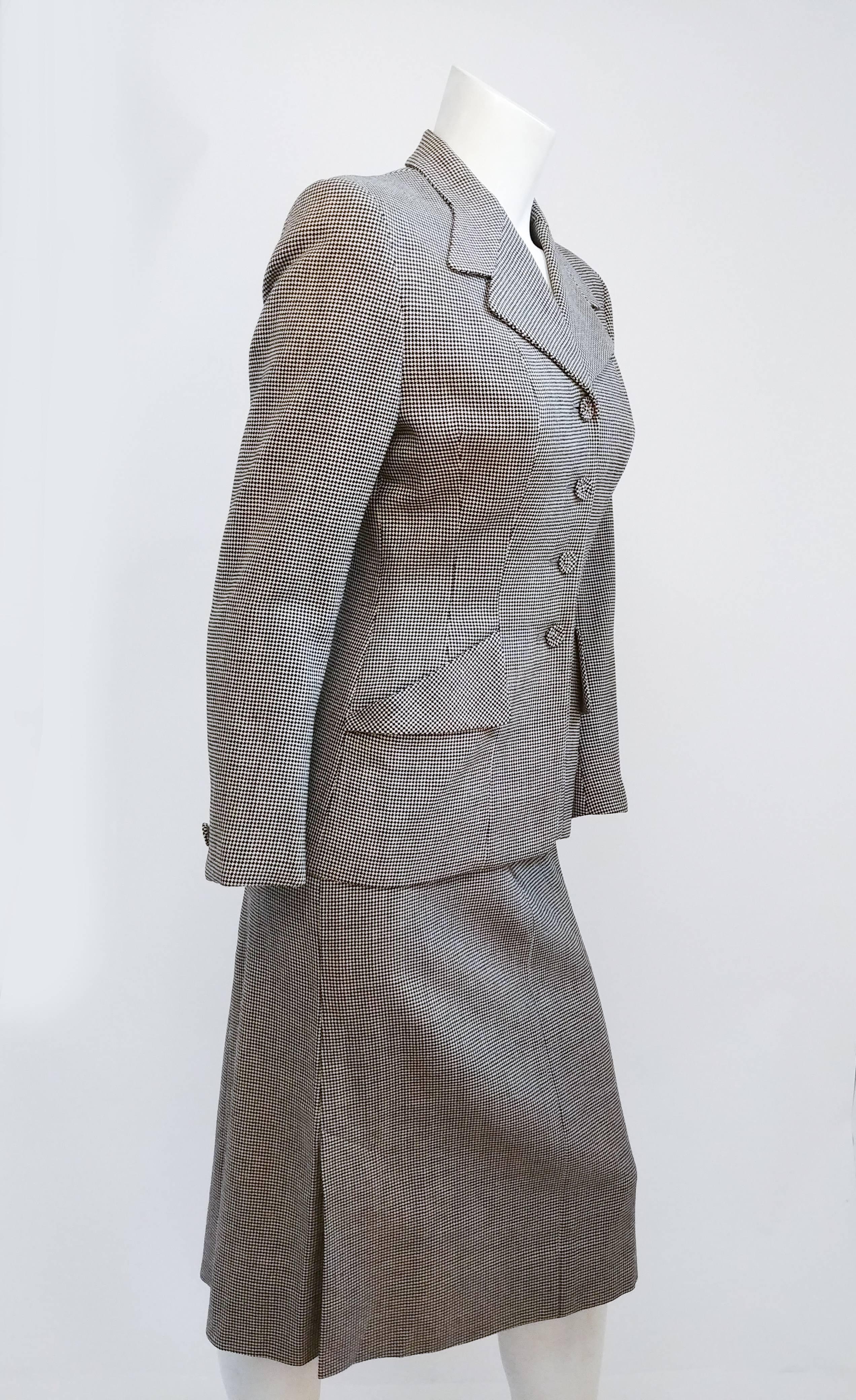 1940s Black & White Houndstooth Suit Set. Interesting notched lapel shape and shaped pocket details, buttons down front. Skirt zips up side, kick pleats at sides for ease of movement. 