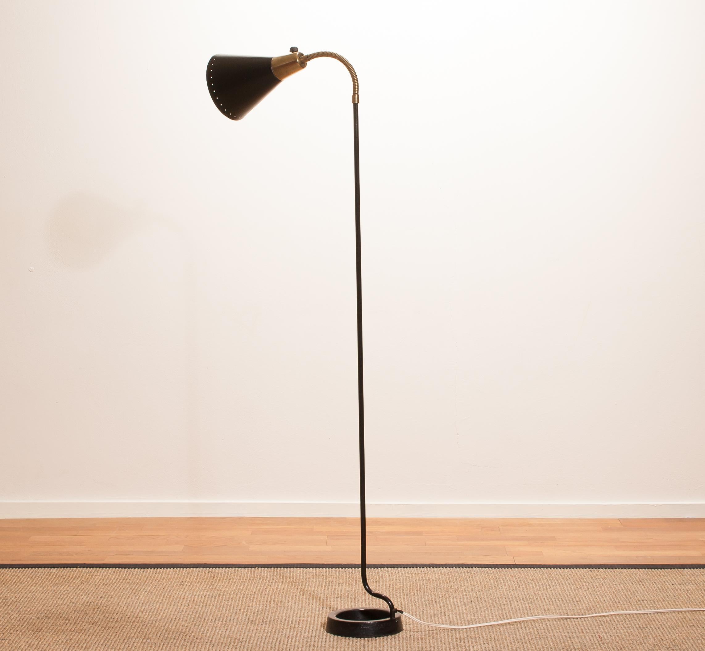 Beautiful floor lamp made in Sweden.
This lamp is made of black metal with brass details and has a very rare Stand.
It has a perforated shade which gives a wonderful shining.
It is in an original and working condition.
Period 1940s
Dimensions