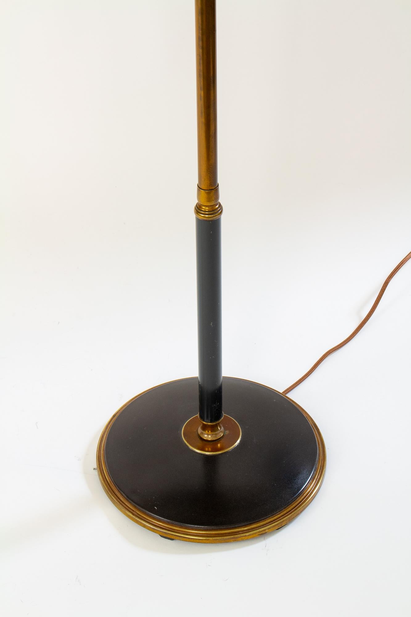 A telescoping floor lamp from the 1940’s with the original black and gold tole finish.  This lamp telescopes from 44” to 59” tall and has a swivel arm to allow perfect placement by your favorite reading chair. A diffuser top and shade prevents