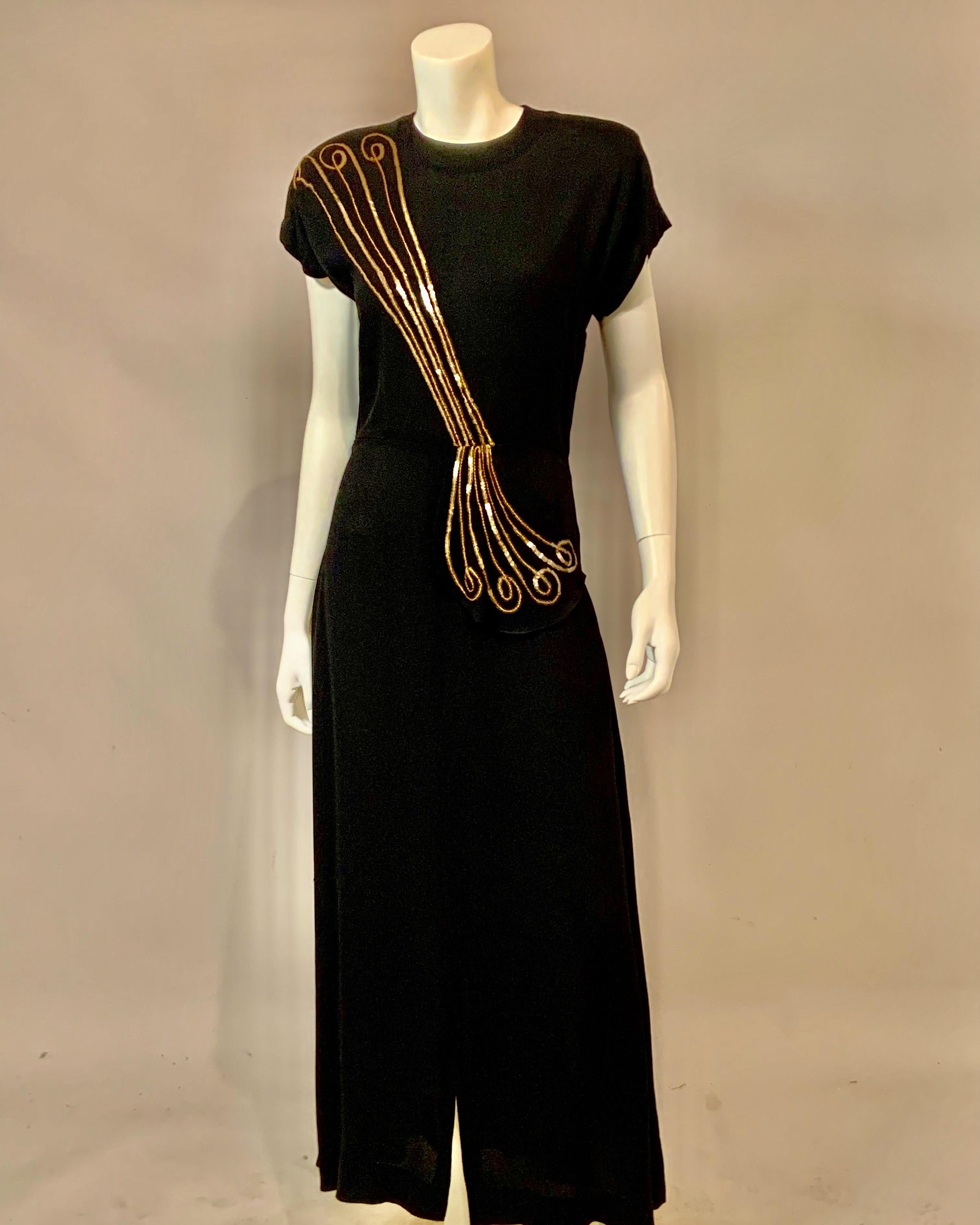 This sleek 1940's black crepe evening dress has a striking design worked in gold sequins from the right shoulder to the left hip. The diagonal lines terminate in a curve at the shoulder and hip transforming a basic dress into a very interesting